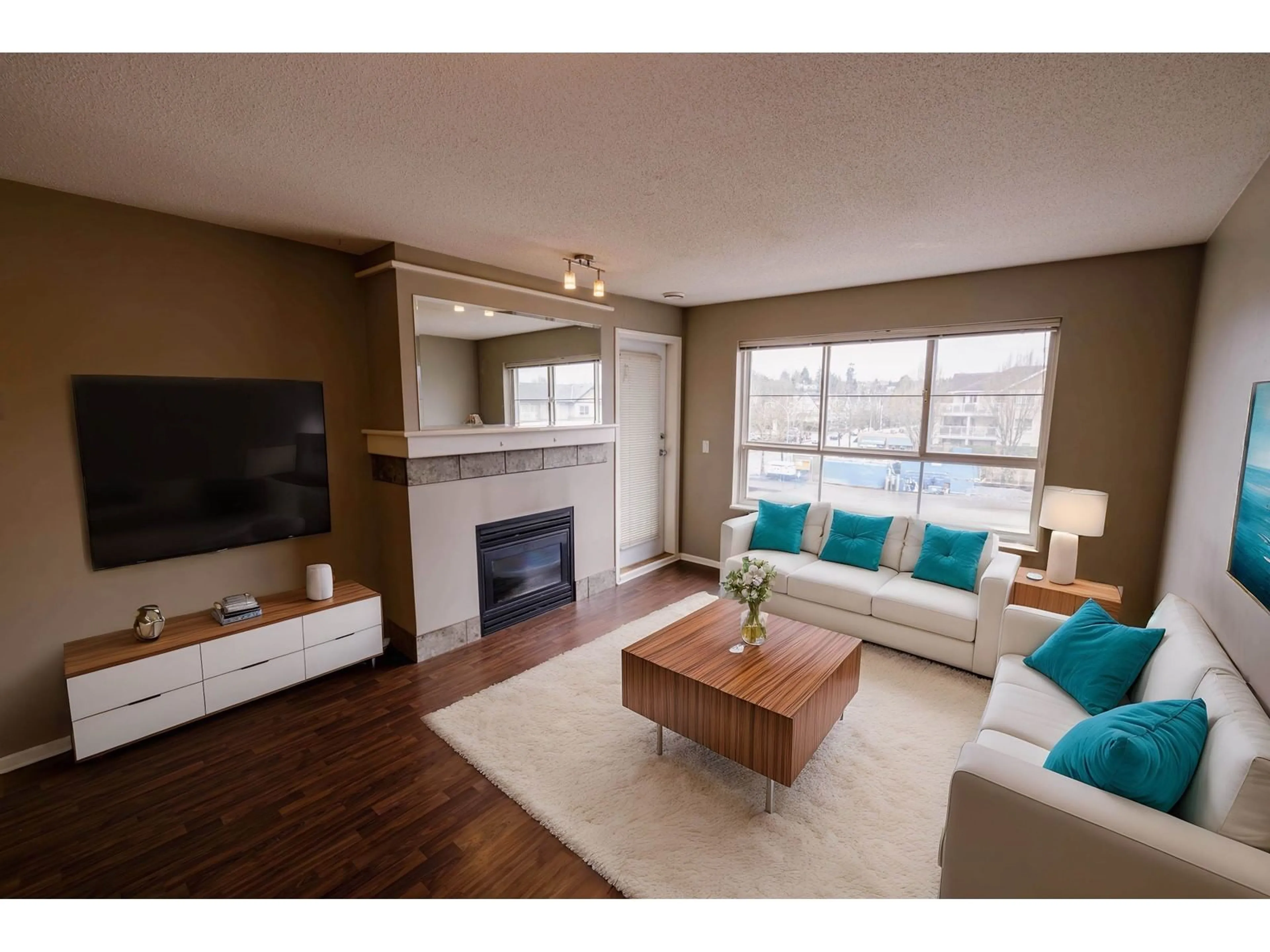 Living room with furniture, wood/laminate floor for 301 - 6336 197, Langley British Columbia V2Y2T2