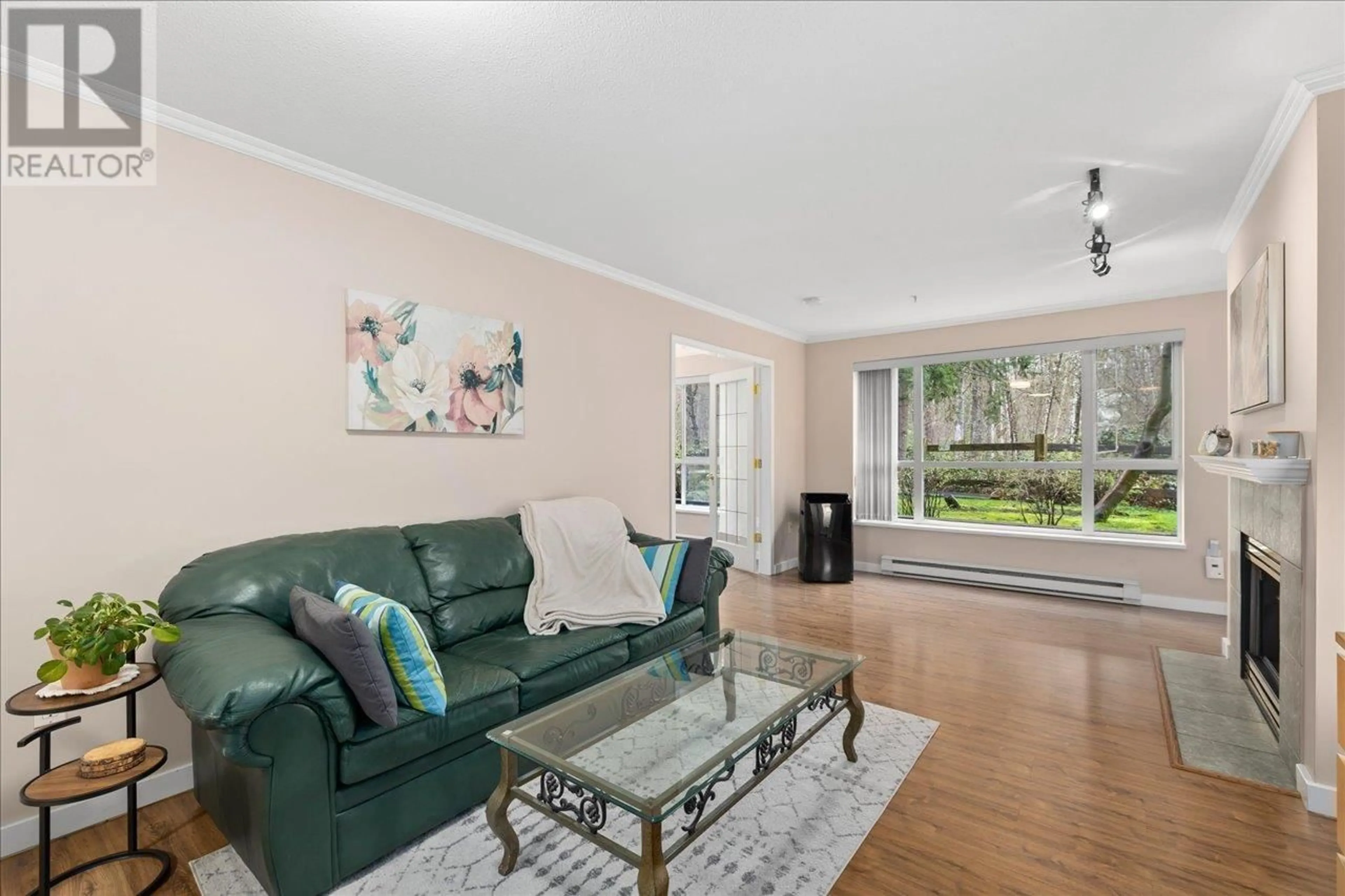 Living room with furniture, wood/laminate floor for 111 - 2559 PARKVIEW LANE, Port Coquitlam British Columbia V3C6M1