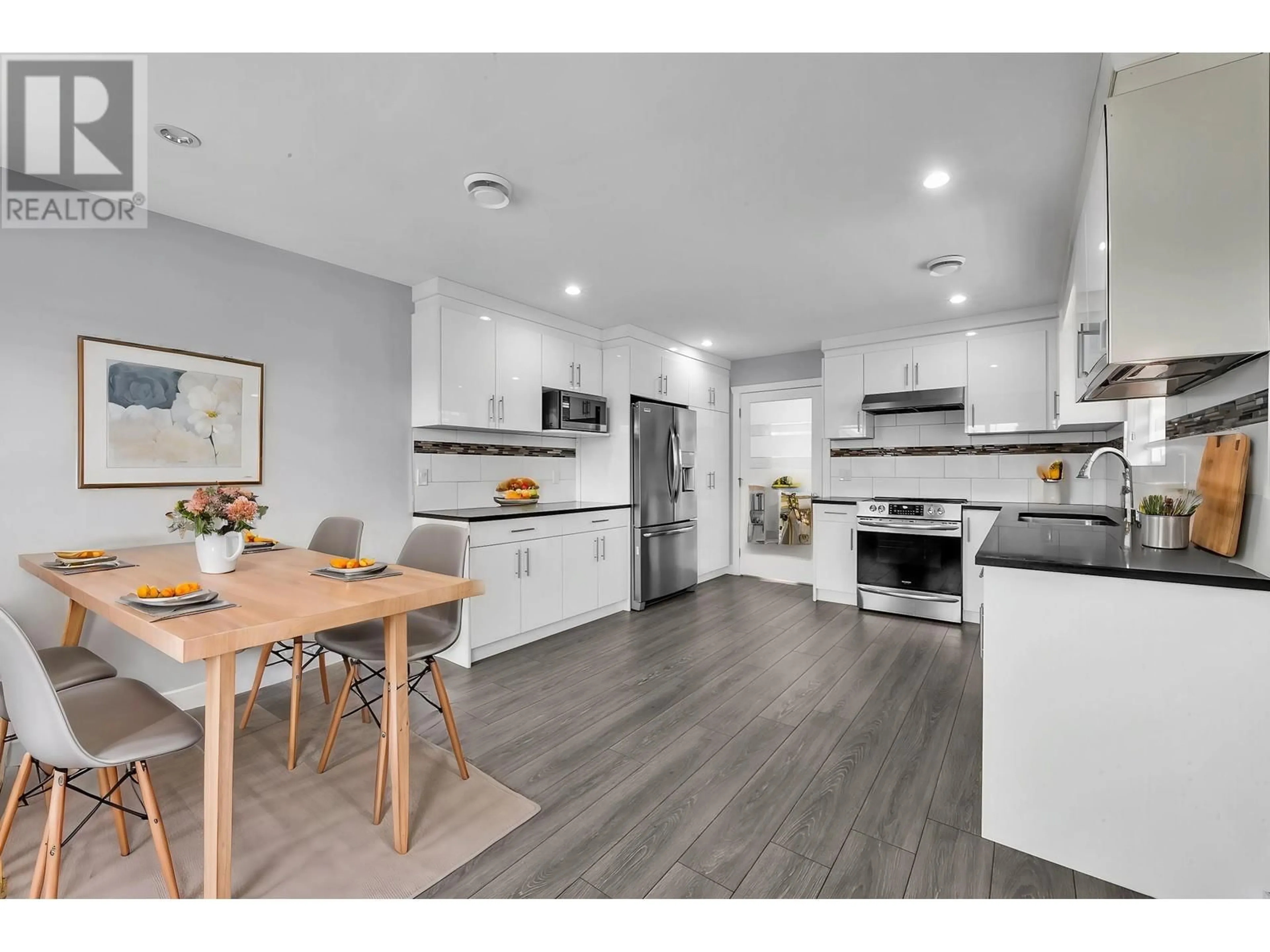 Open concept kitchen, wood/laminate floor for 4620 RIVER ROAD, Delta British Columbia V4K1S4