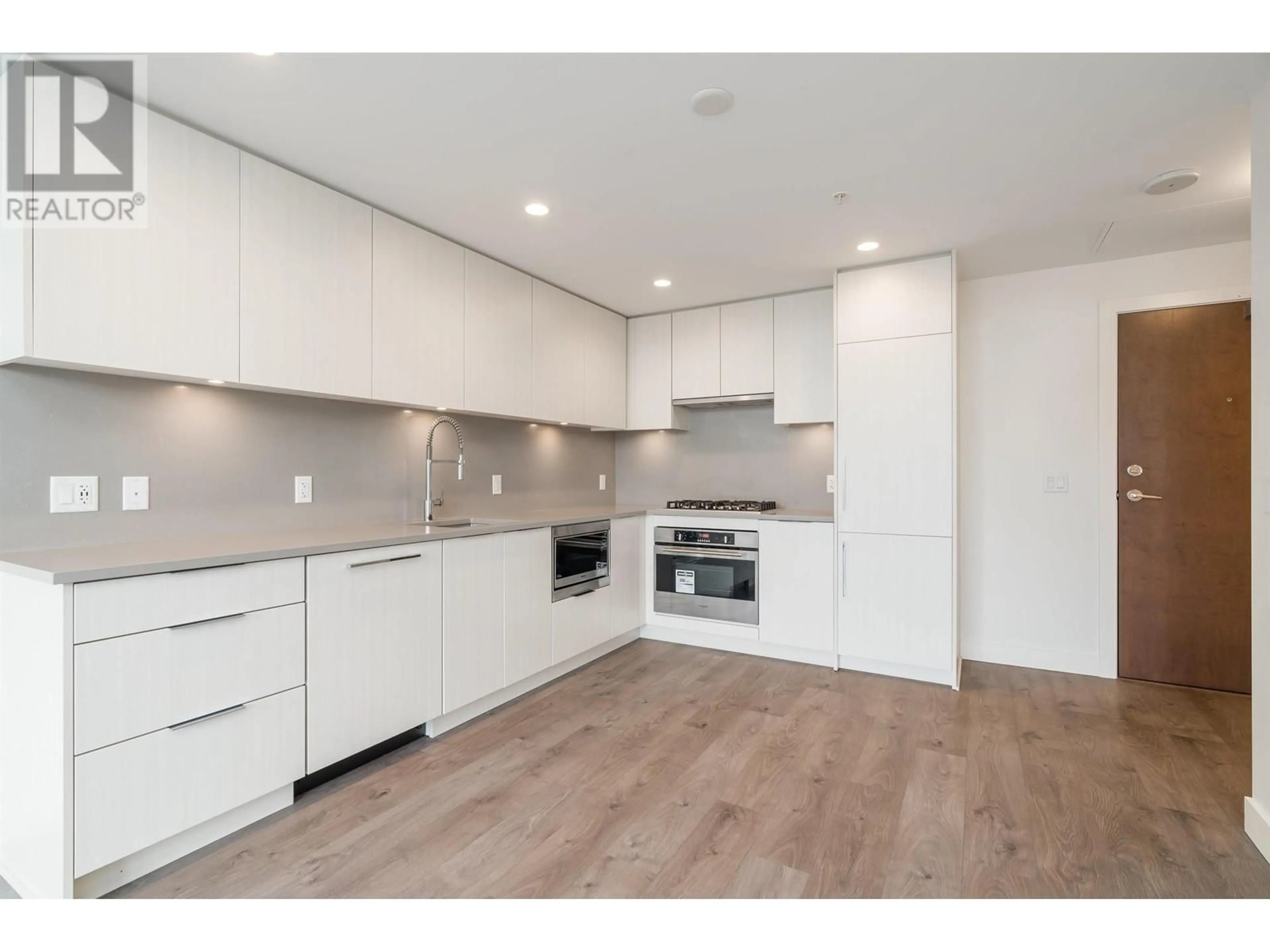 Open concept kitchen, wood/laminate floor for 702 - 4465 JUNEAU STREET, Burnaby British Columbia V5C0L8