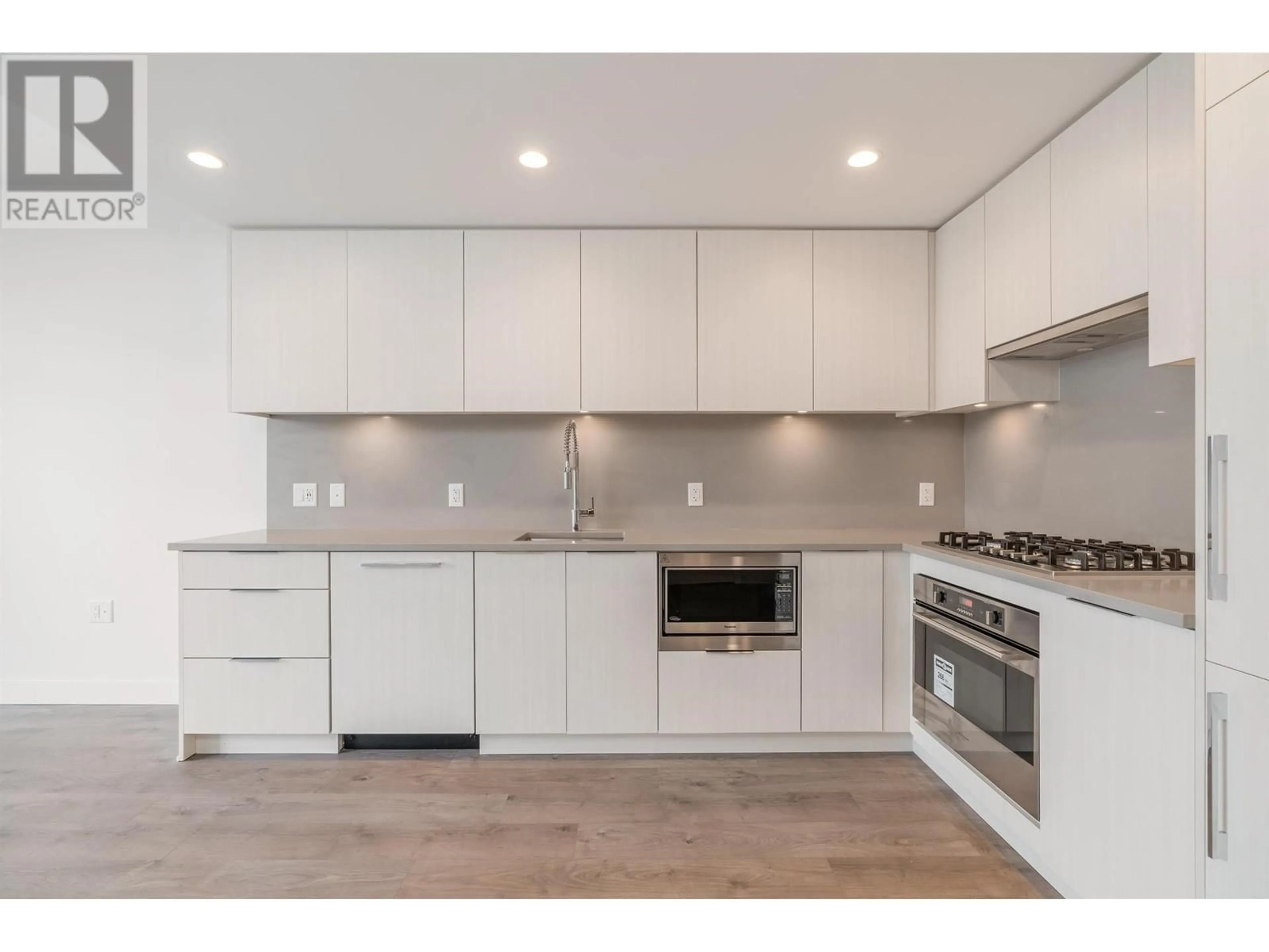 Open concept kitchen, wood/laminate floor for 702 - 4465 JUNEAU STREET, Burnaby British Columbia V5C0L8