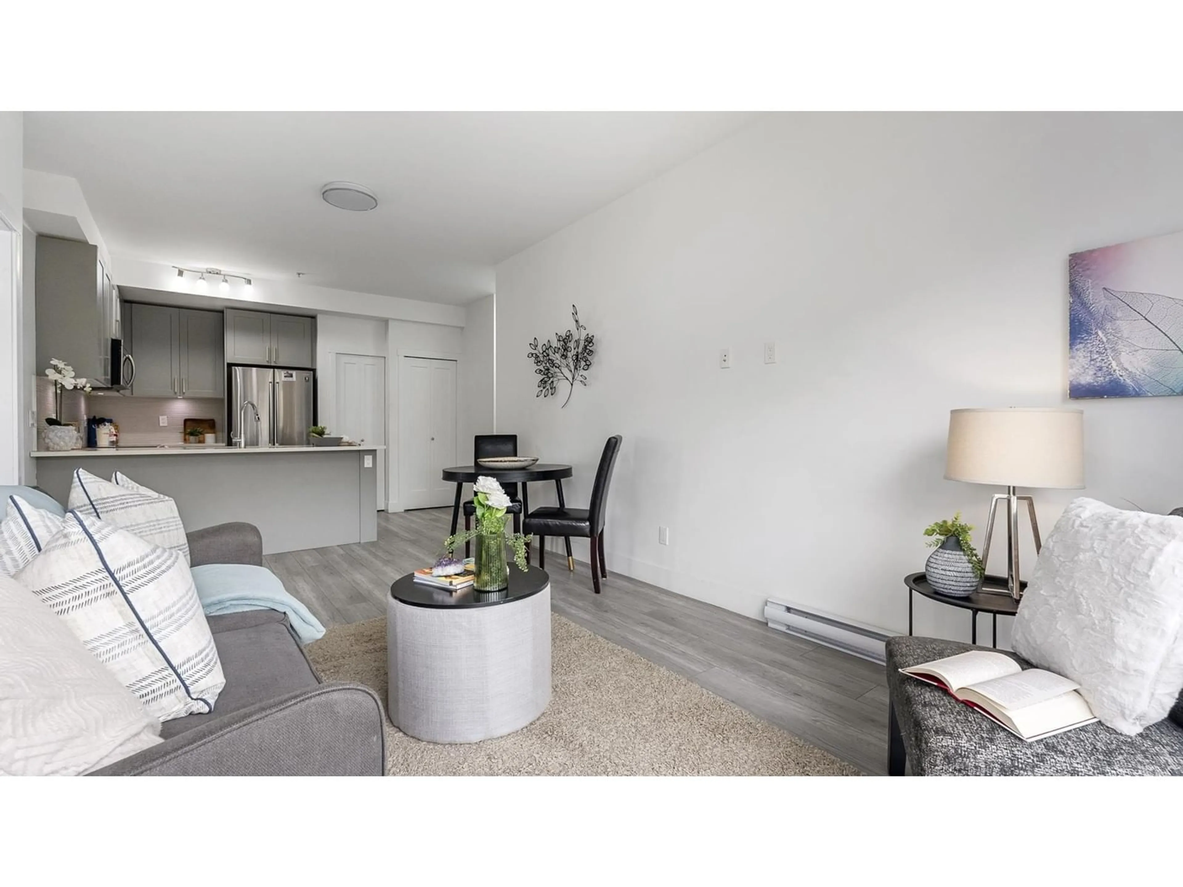 Living room with furniture, wood/laminate floor for 608 - 13978 FRASER, Surrey British Columbia V3T0P2