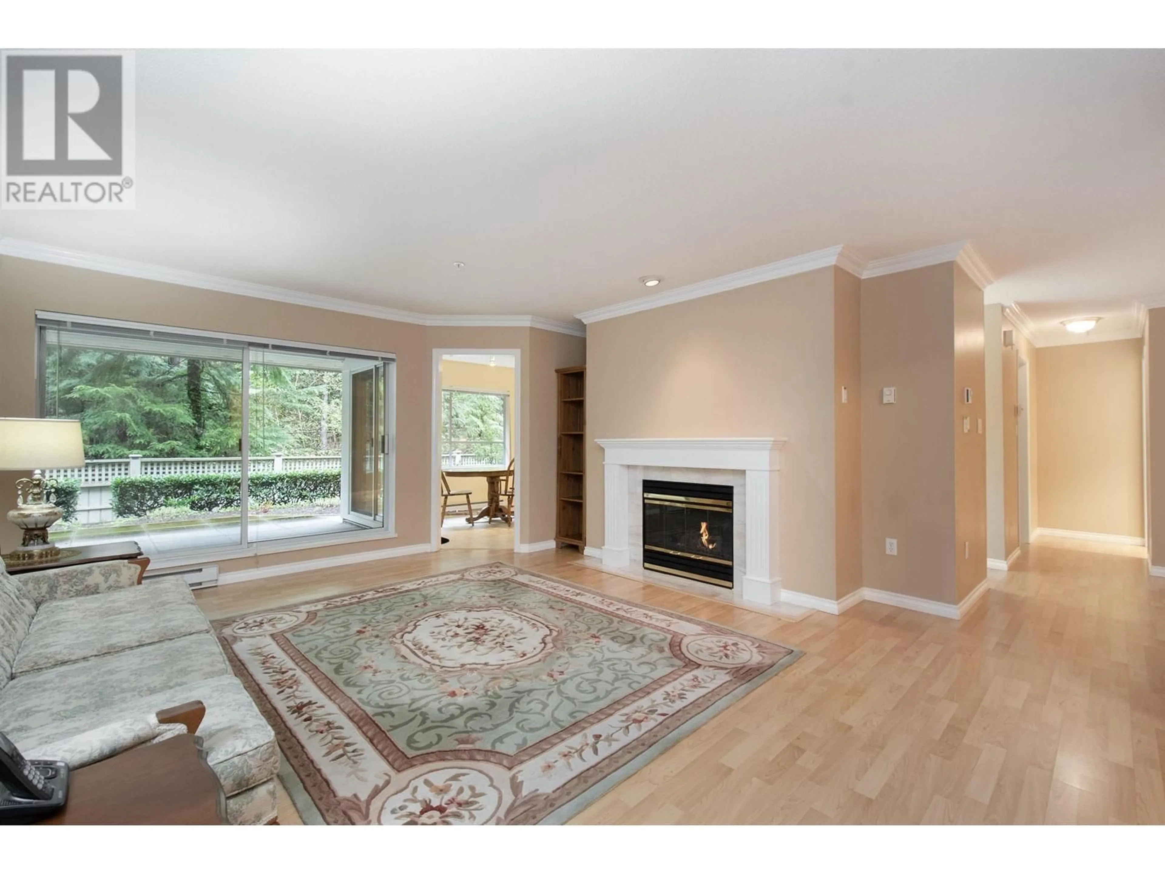 Living room with furniture, wood/laminate floor for 105 - 3680 BANFF COURT, North Vancouver British Columbia V7H2Y7