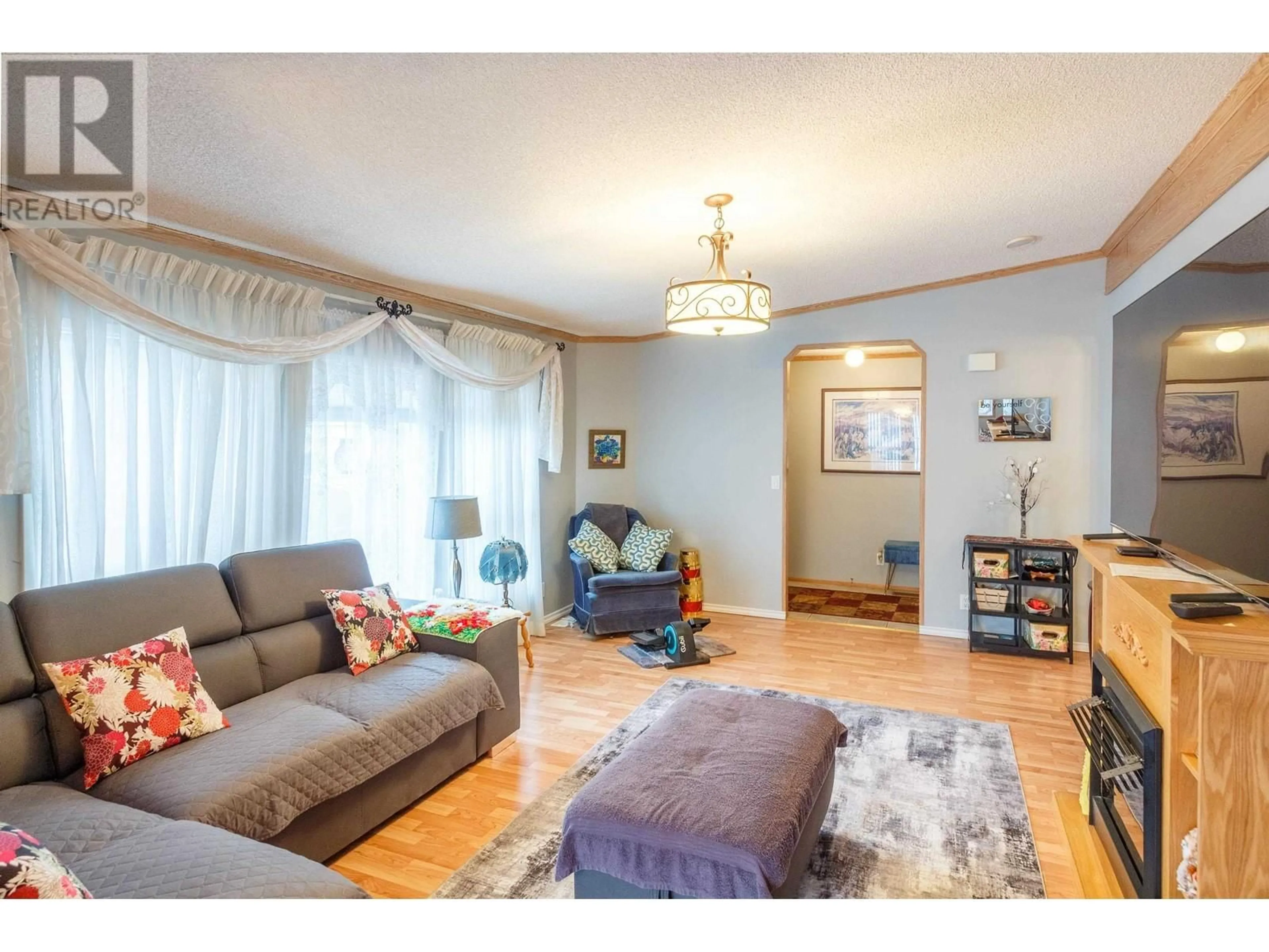 Living room with furniture, wood/laminate floor for 46 - 1000 INVERNESS ROAD, Prince George British Columbia V2K4V1