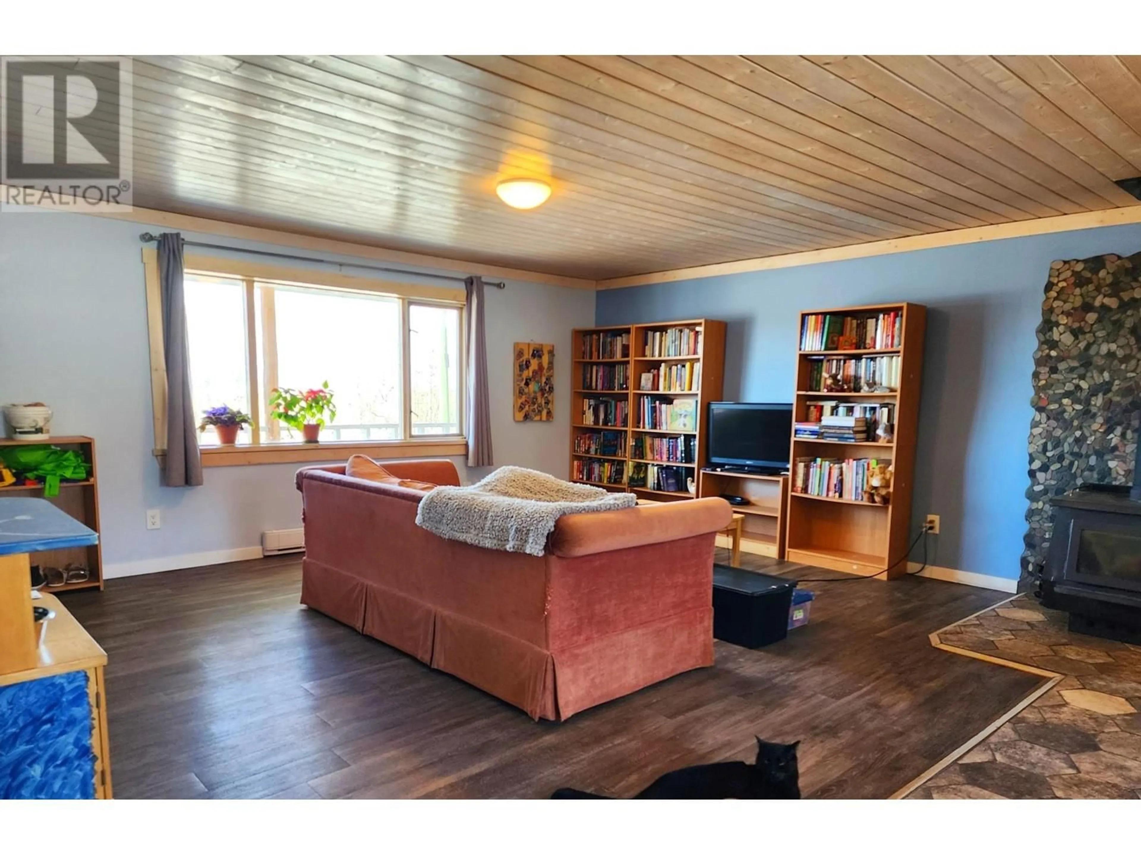 Living room with furniture, wood/laminate floor for 7331 UNCHA LAKE ROAD, Burns Lake British Columbia V0J1E0