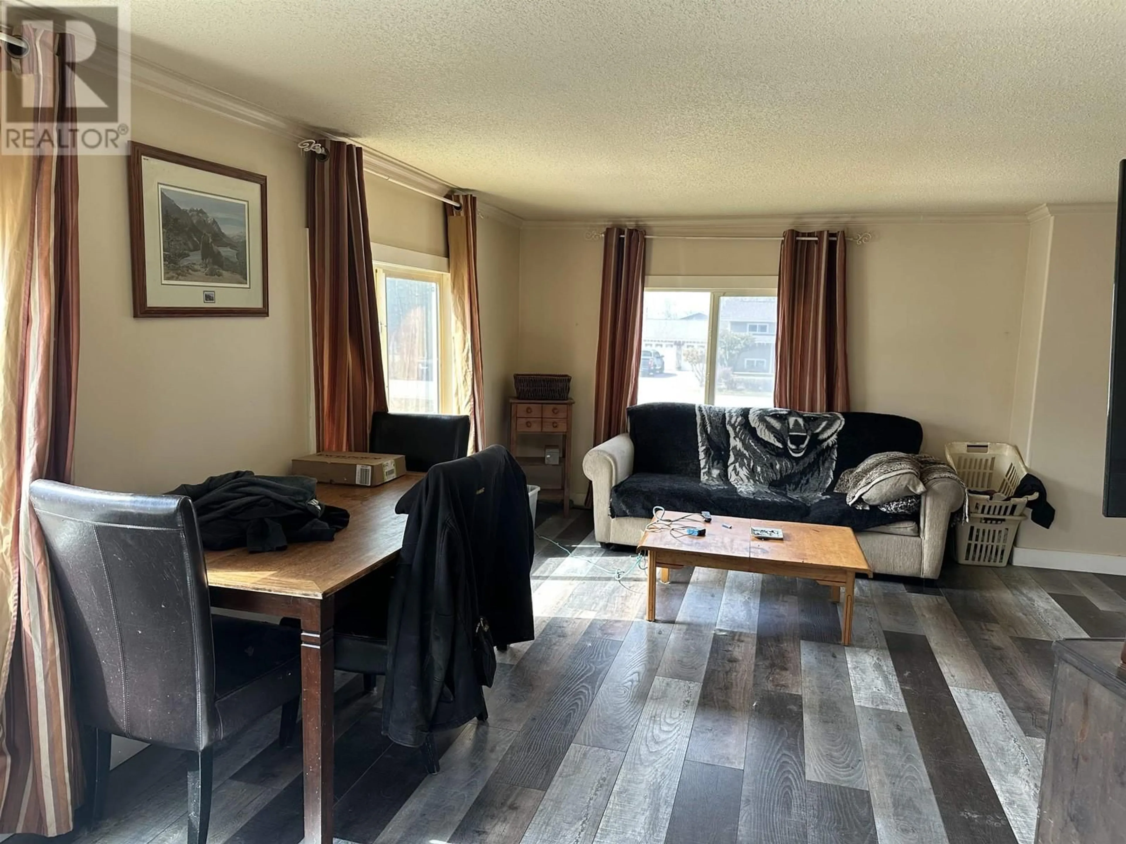 Living room with furniture, wood/laminate floor for 7183 253 ROAD, Fort St. John British Columbia V0C1C6