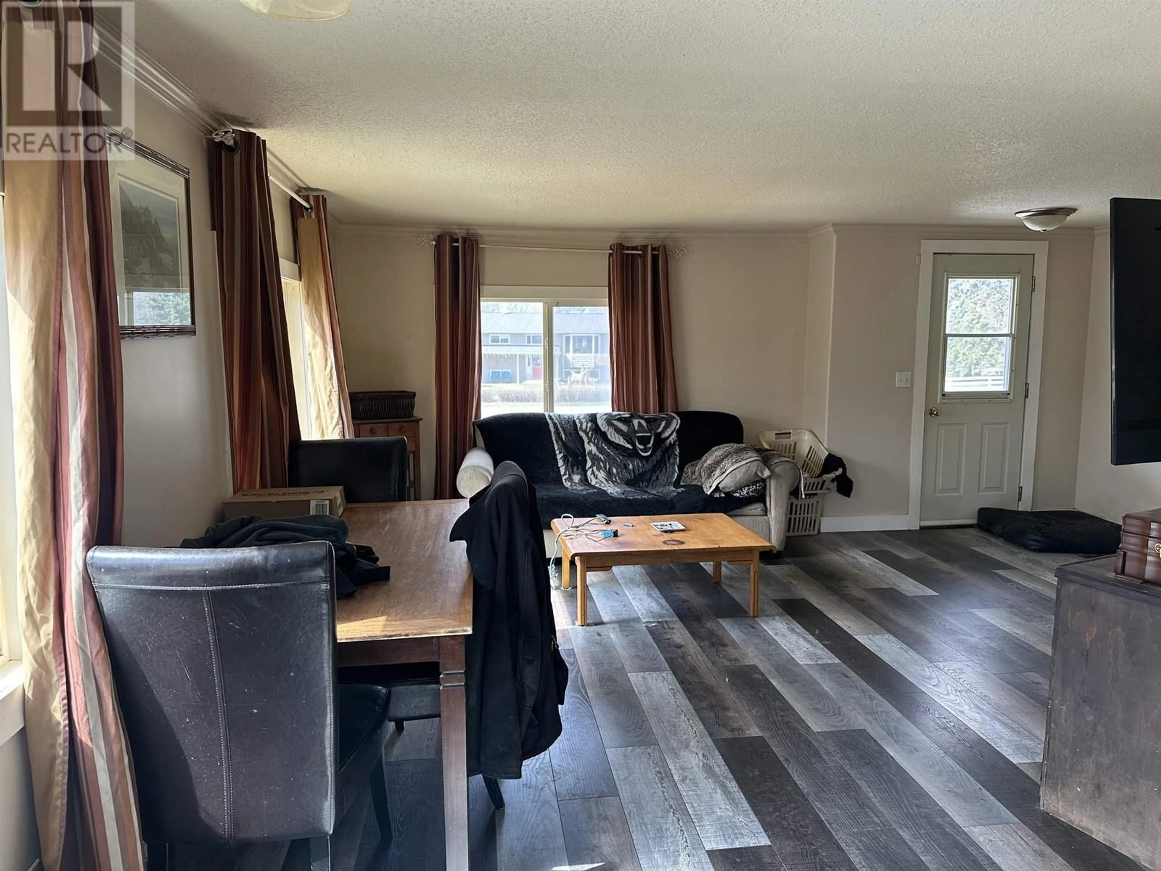 Living room with furniture, wood/laminate floor for 7183 253 ROAD, Fort St. John British Columbia V0C1C6