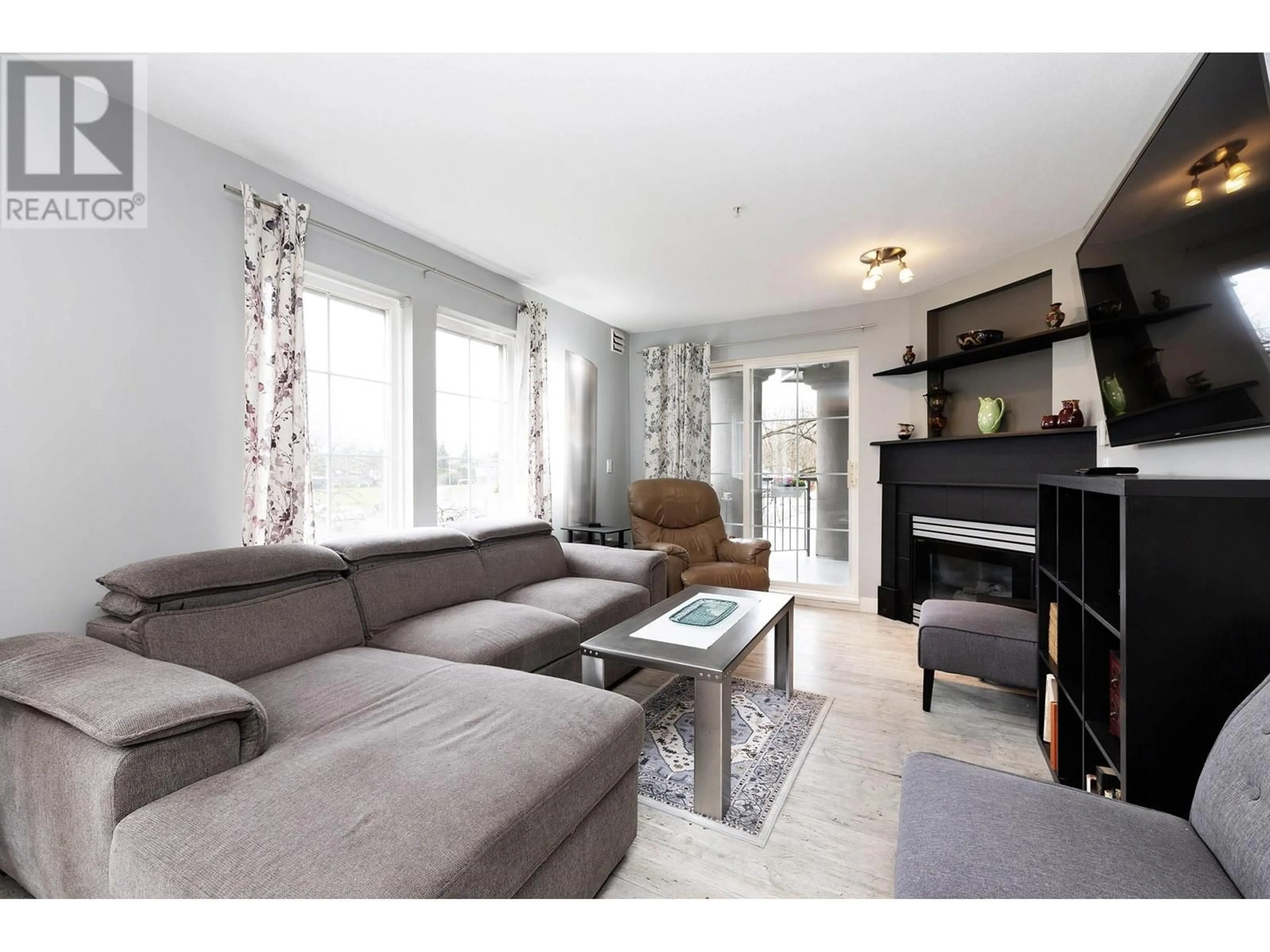 Living room with furniture, wood/laminate floor for 203 - 1669 GRANT AVENUE, Port Coquitlam British Columbia V3B7W9