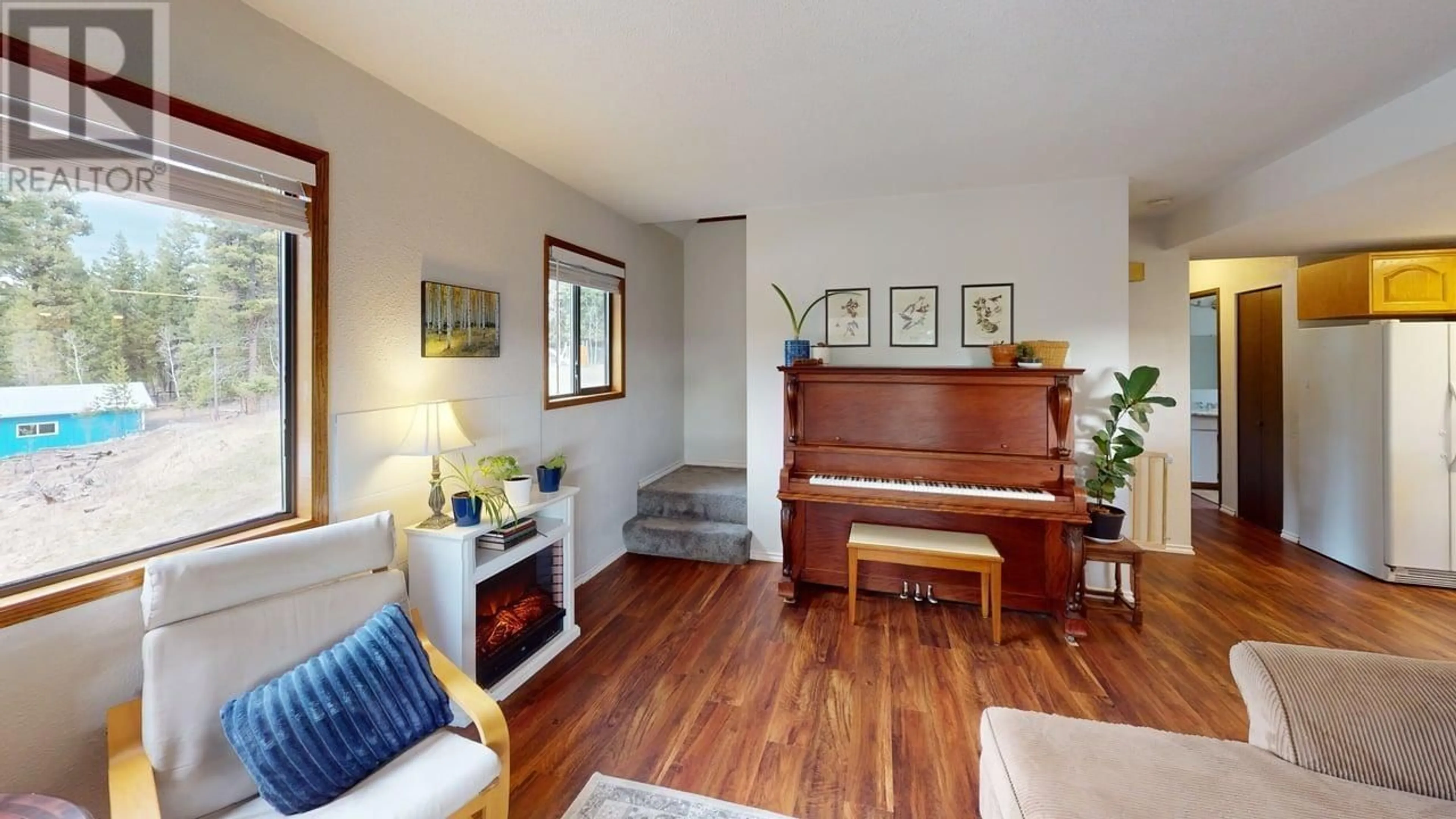 Living room with furniture, wood/laminate floor for 4917 KITWANGA DRIVE, 108 Mile Ranch British Columbia V0K2Z0