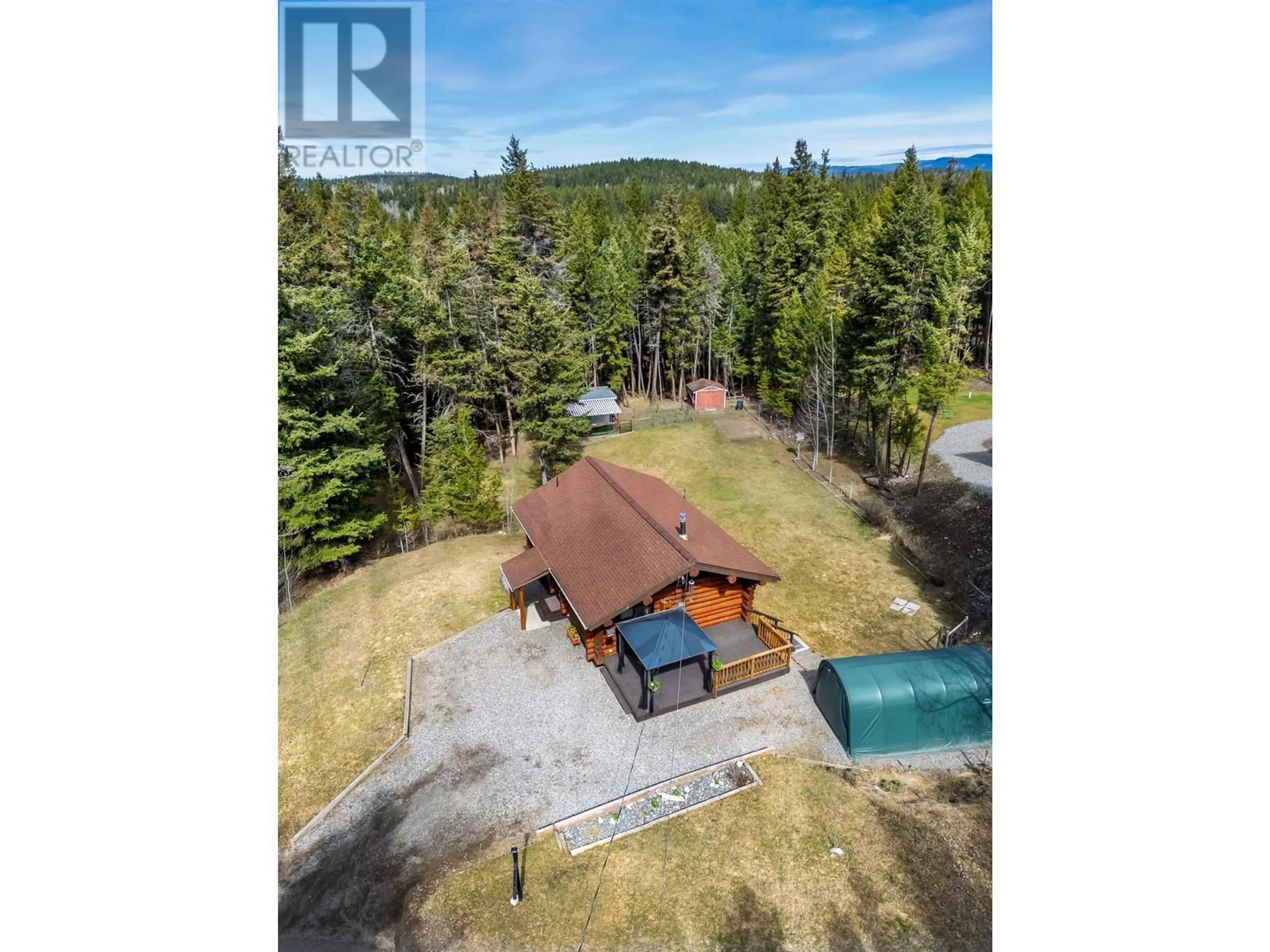 A pic from outside/outdoor area/front of a property/back of a property/a pic from drone, unknown for 5231 DAVIS ROAD, 108 Mile Ranch British Columbia V0K2Z0