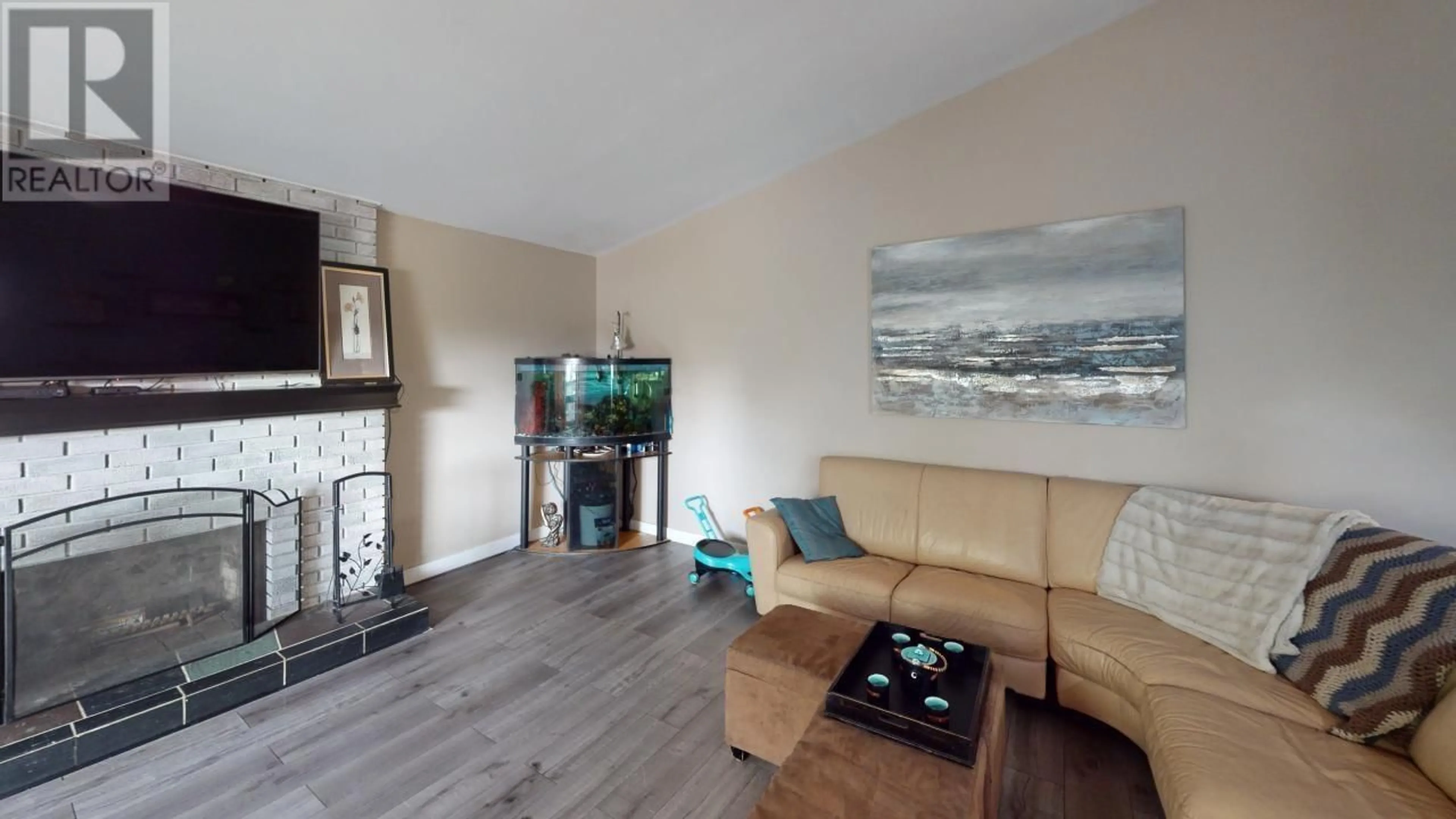 Living room with furniture, wood/laminate floor for 9308 112 AVENUE, Fort St. John British Columbia V1J2V9