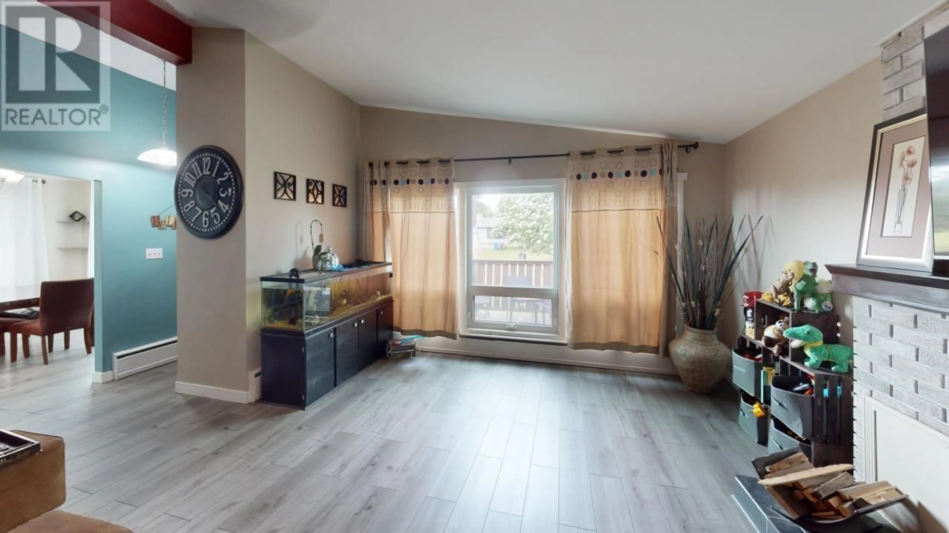 Living room with furniture, wood/laminate floor for 9308 112 AVENUE, Fort St. John British Columbia V1J2V9
