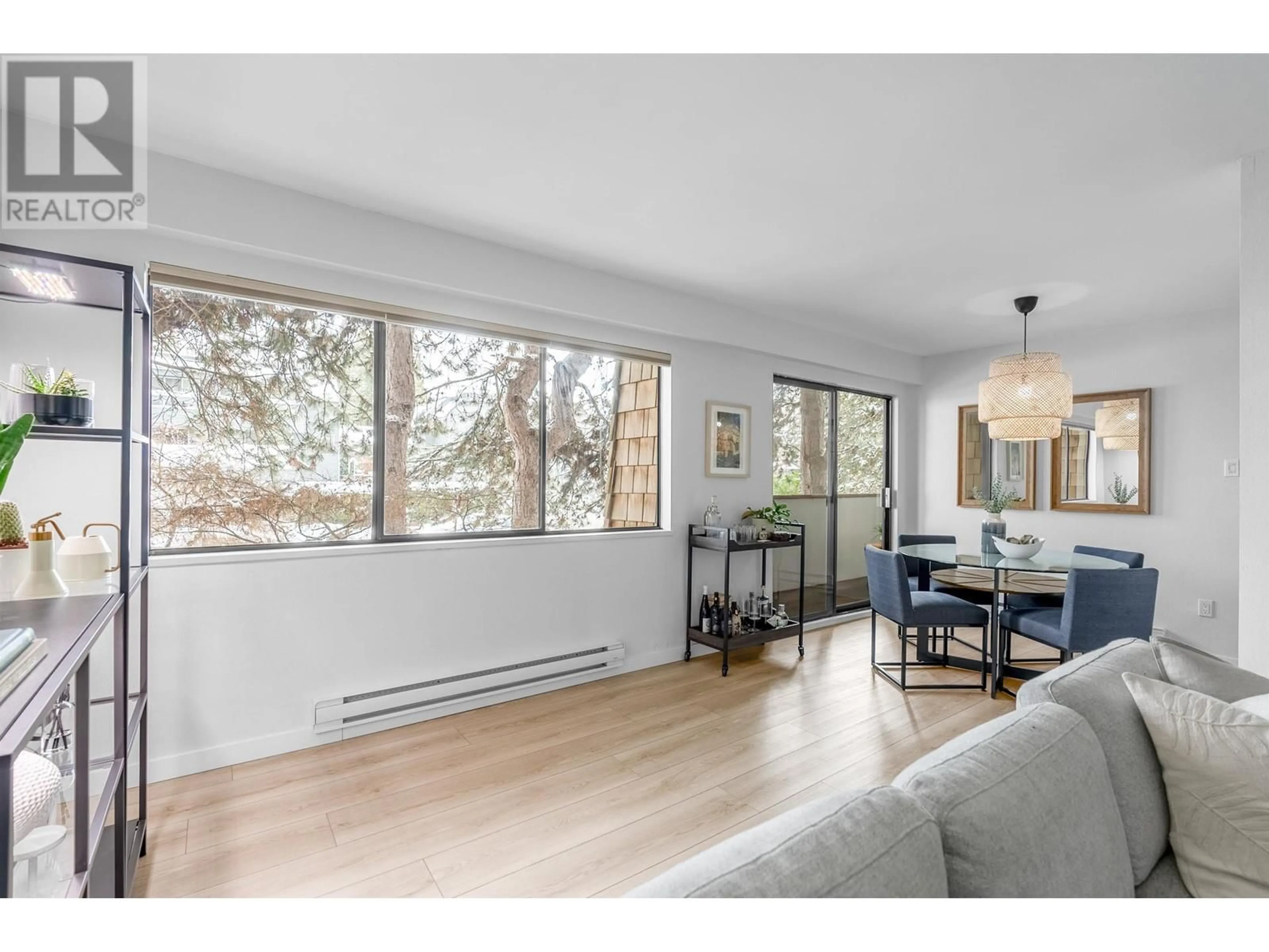 Living room with furniture, wood/laminate floor for 204 - 1721 ST. GEORGES AVENUE, North Vancouver British Columbia V7L3J8