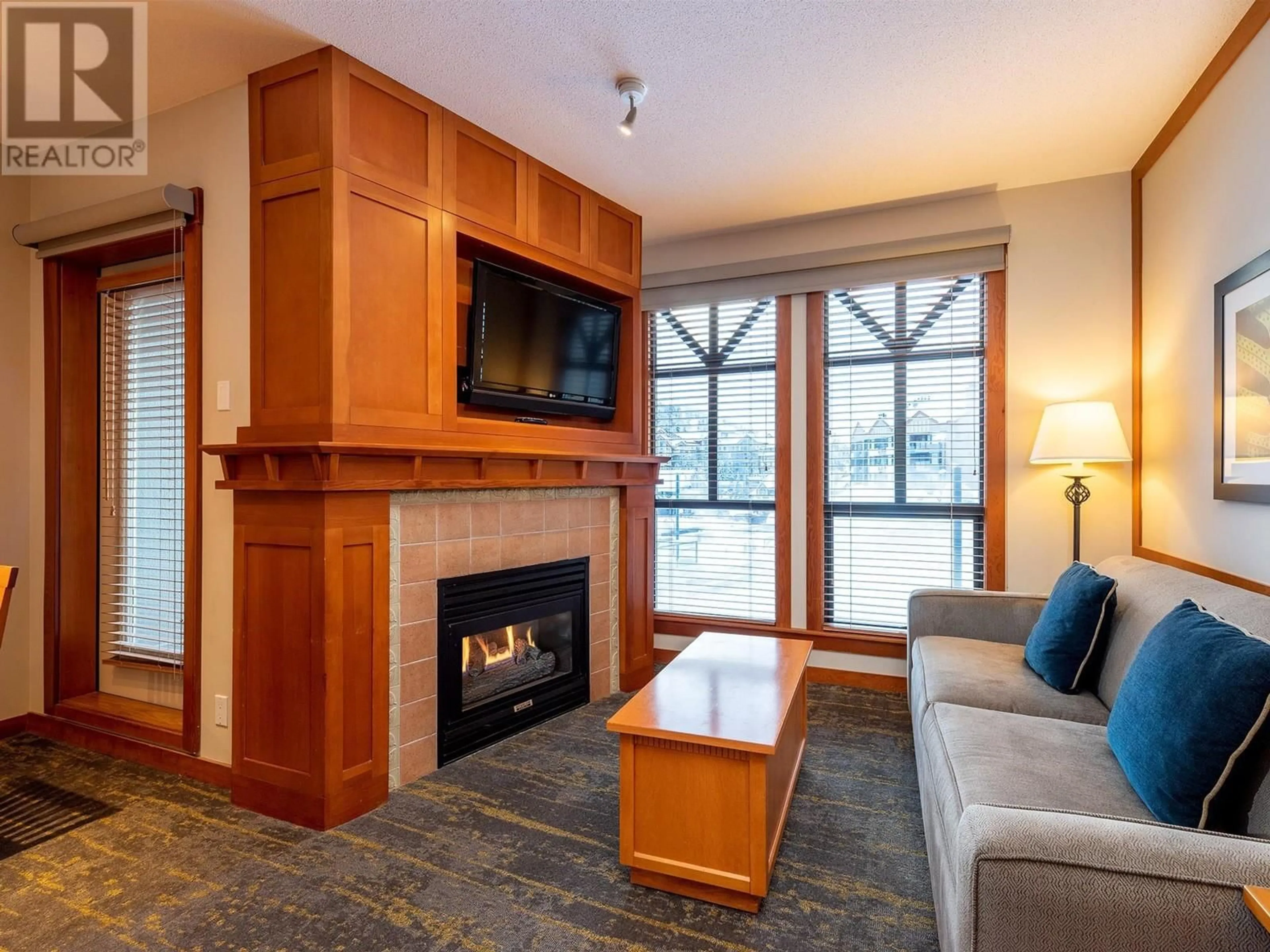 Living room with furniture, wood/laminate floor for 218 - 4320 SUNDIAL CRESCENT, Whistler British Columbia V8E1G6