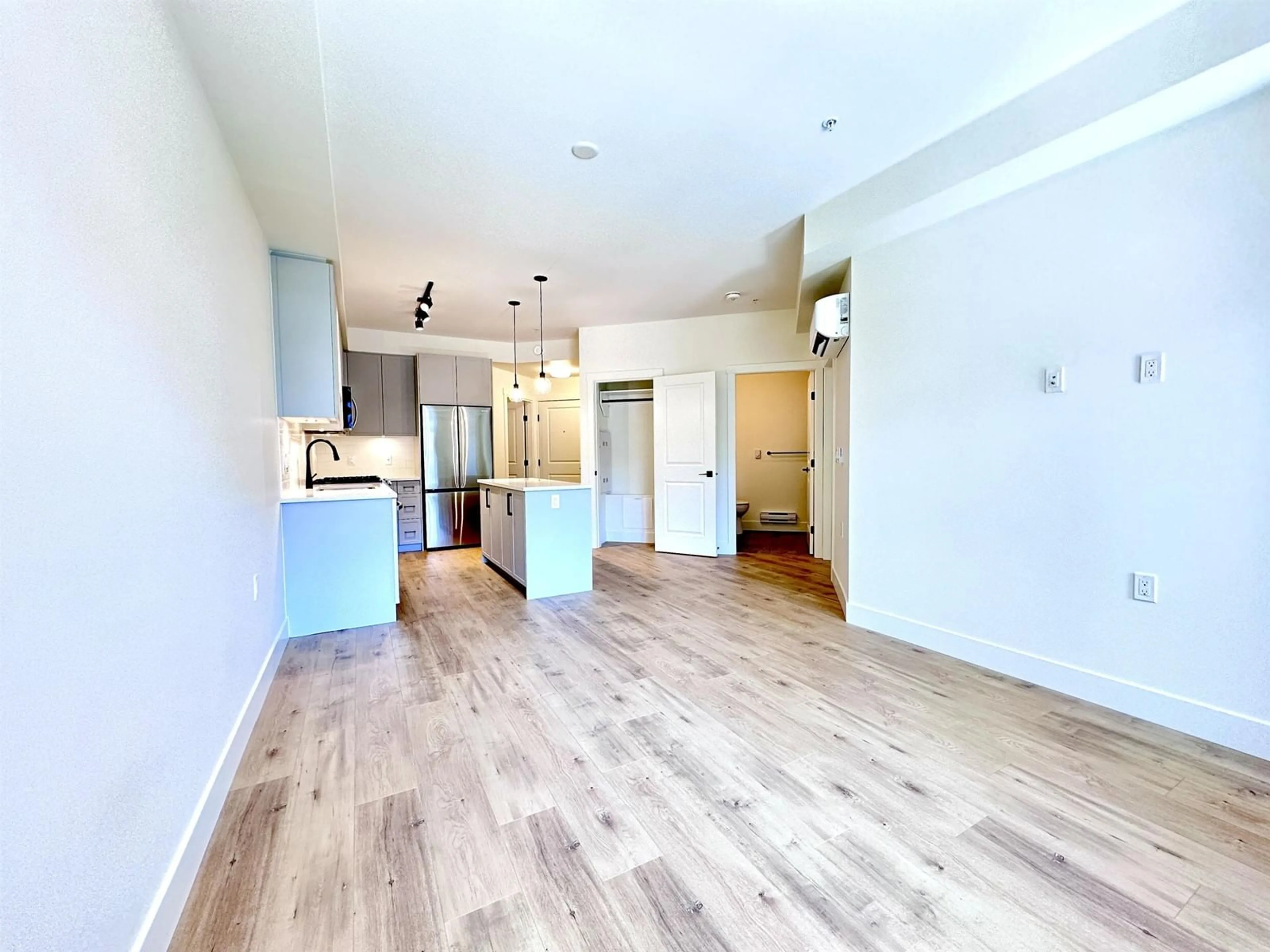 Open concept kitchen, wood/laminate floor for 328 - 7506 199A, Langley British Columbia V2Y3K9
