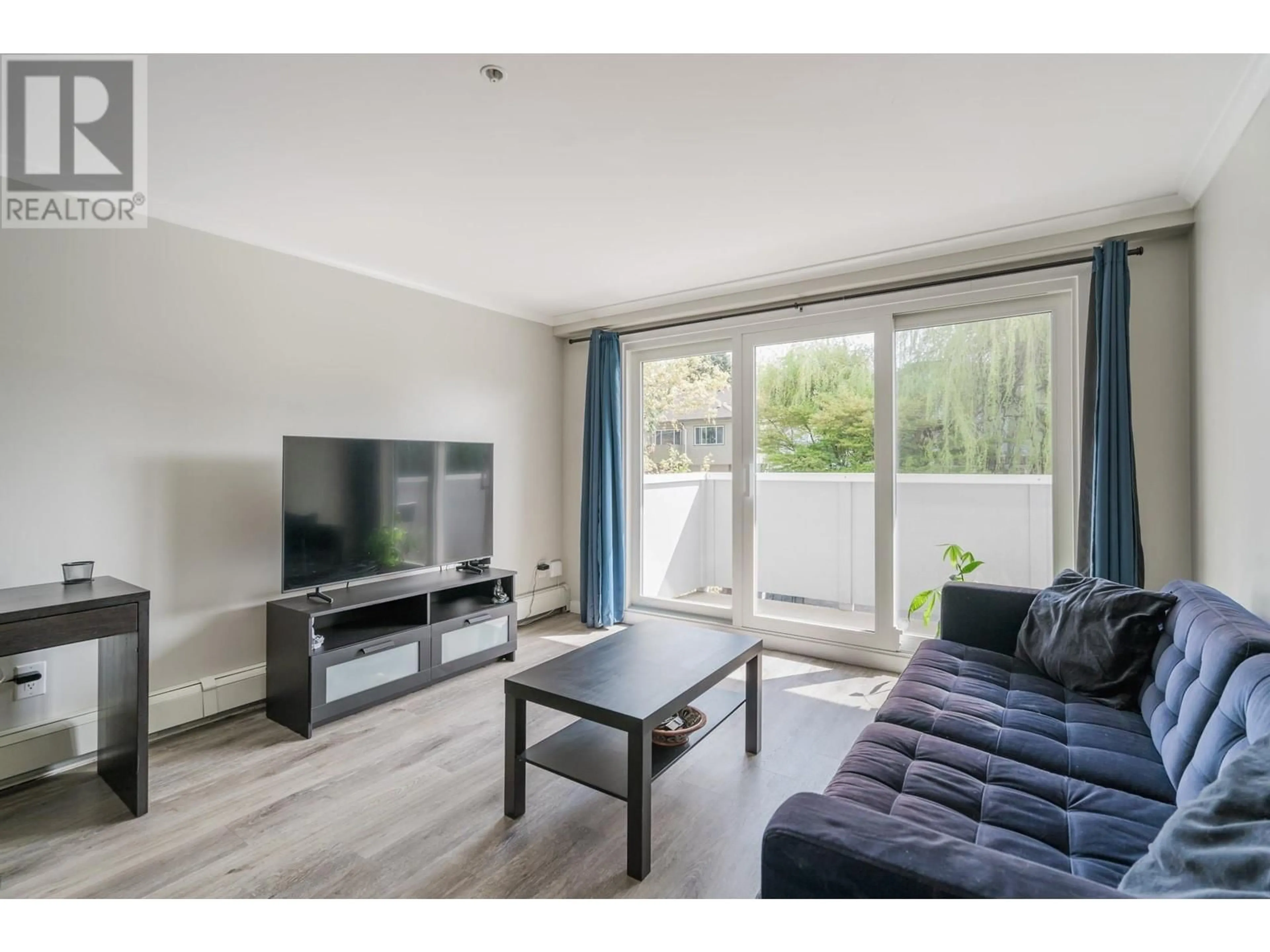 Living room with furniture, wood/laminate floor for 203 - 2036 COQUITLAM AVENUE, Port Coquitlam British Columbia V3B1J5