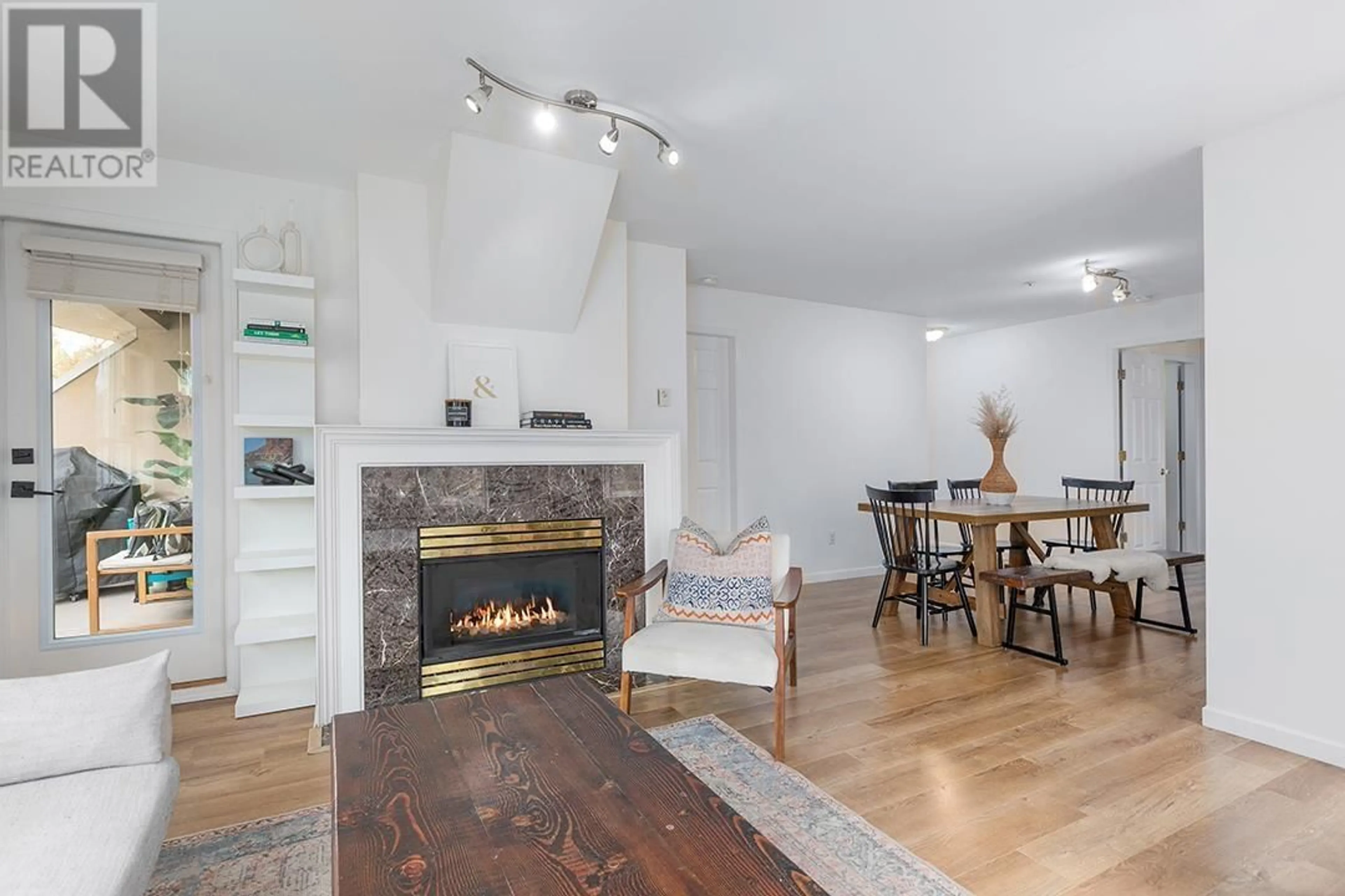Living room with furniture, wood/laminate floor for 208 - 2285 PITT RIVER ROAD, Port Coquitlam British Columbia V3C1R7
