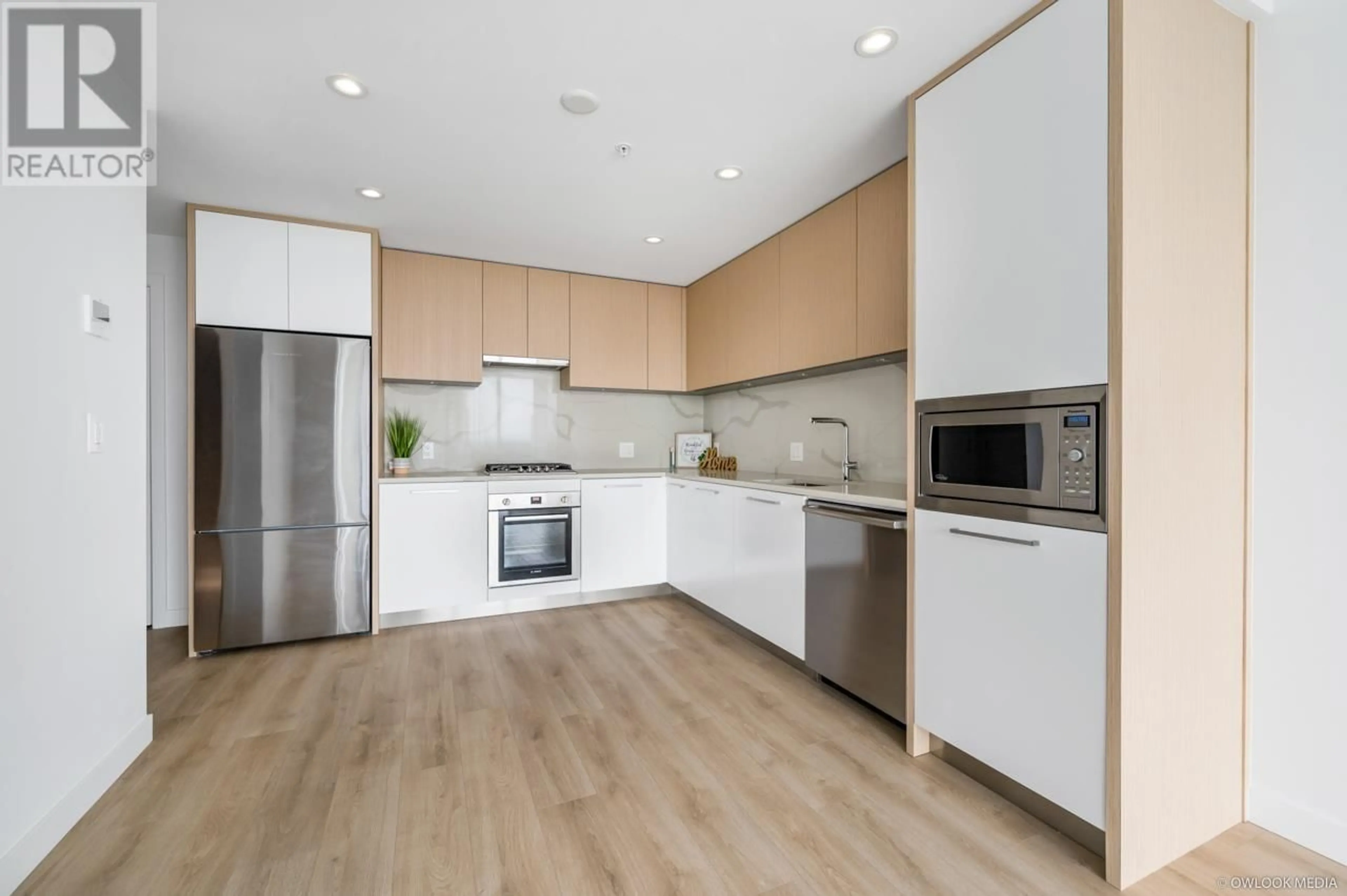 Open concept kitchen, wood/laminate floor for 2607 - 567 CLARKE ROAD, Coquitlam British Columbia V3J0K7