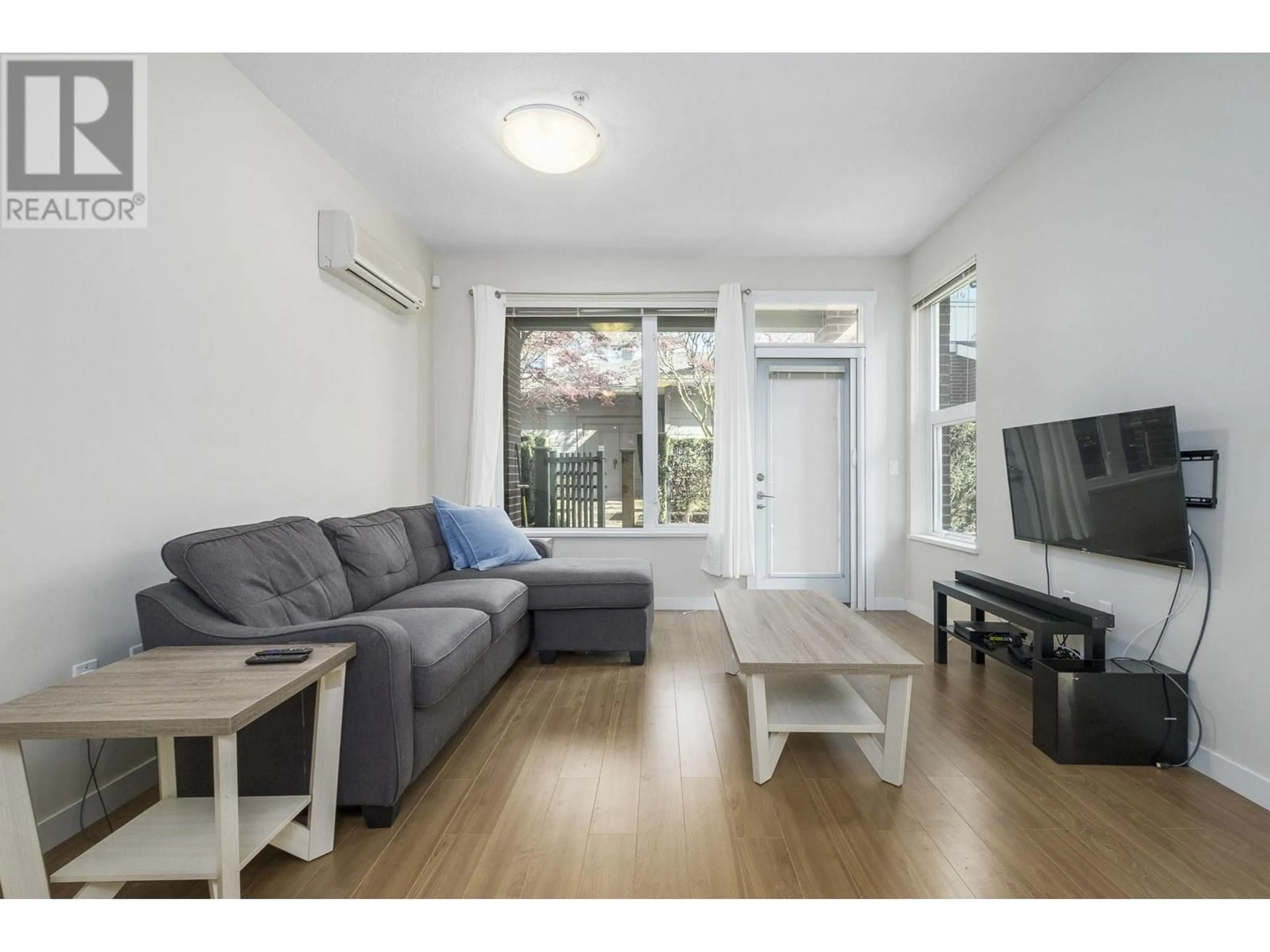 Living room with furniture, wood/laminate floor for 121 - 9399 ODLIN ROAD, Richmond British Columbia V6X0J6