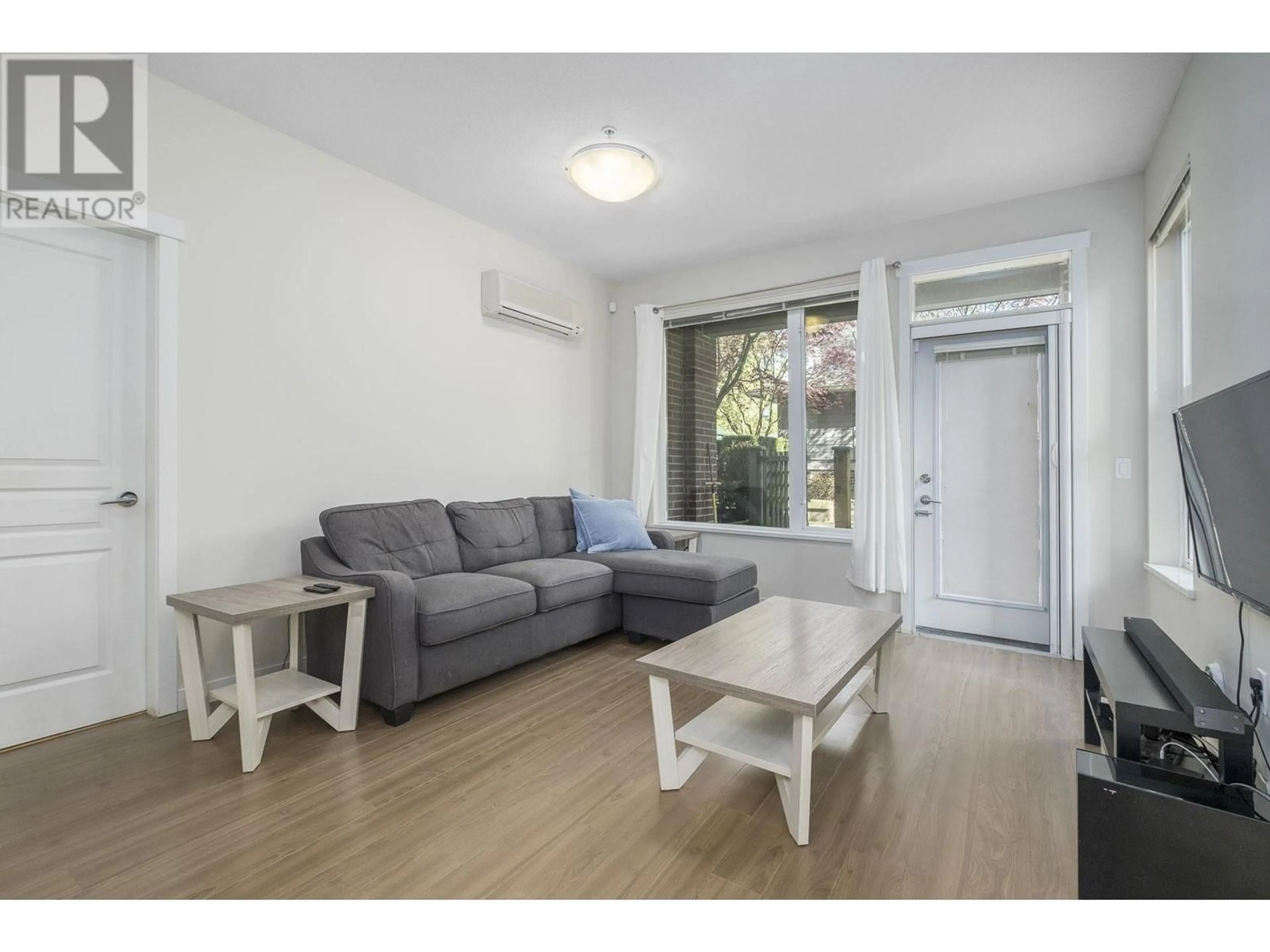 Living room with furniture, wood/laminate floor for 121 - 9399 ODLIN ROAD, Richmond British Columbia V6X0J6