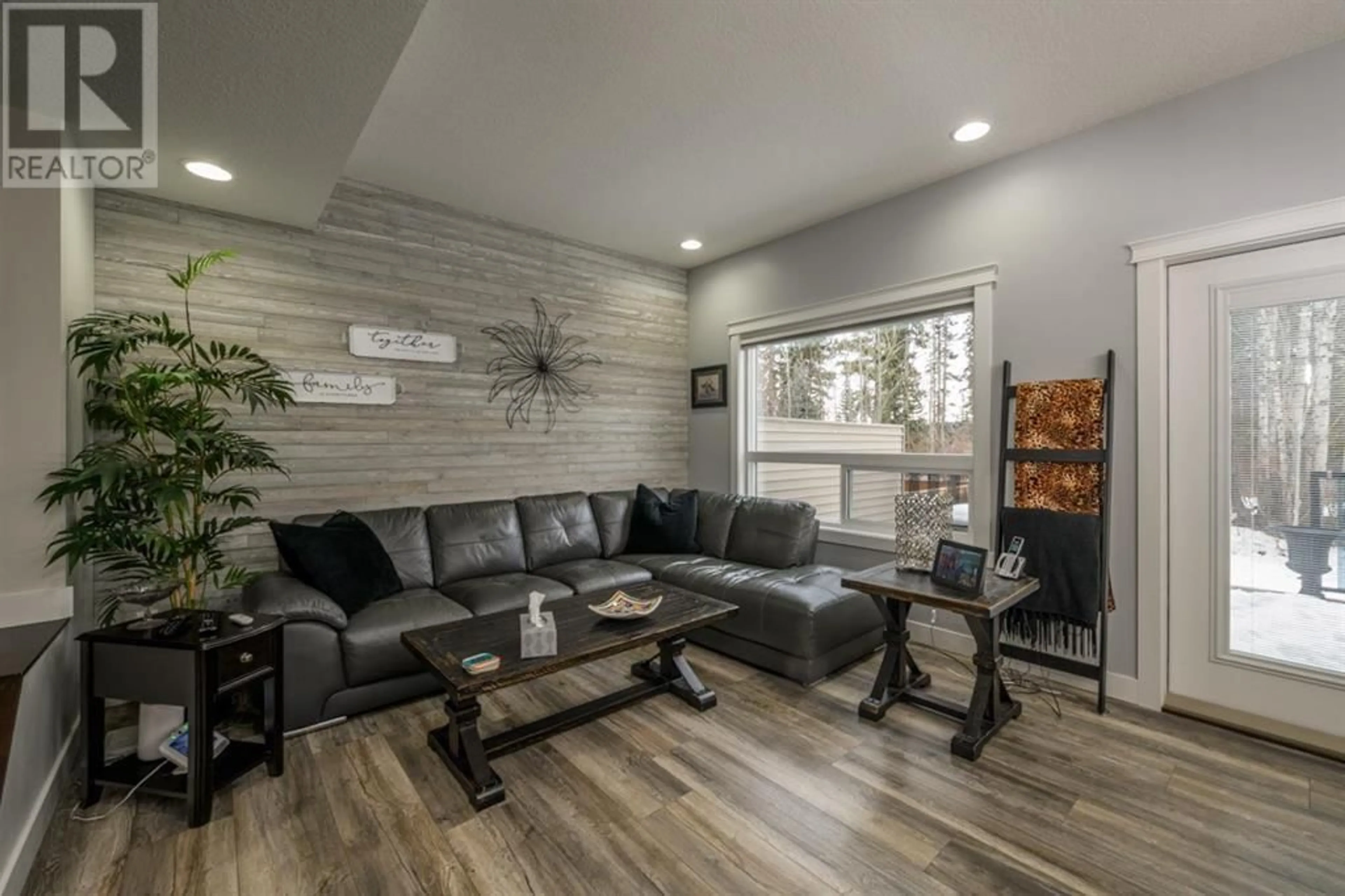 Living room with furniture, wood/laminate floor for 7654 CREEKSIDE WAY, Prince George British Columbia V2N0C2