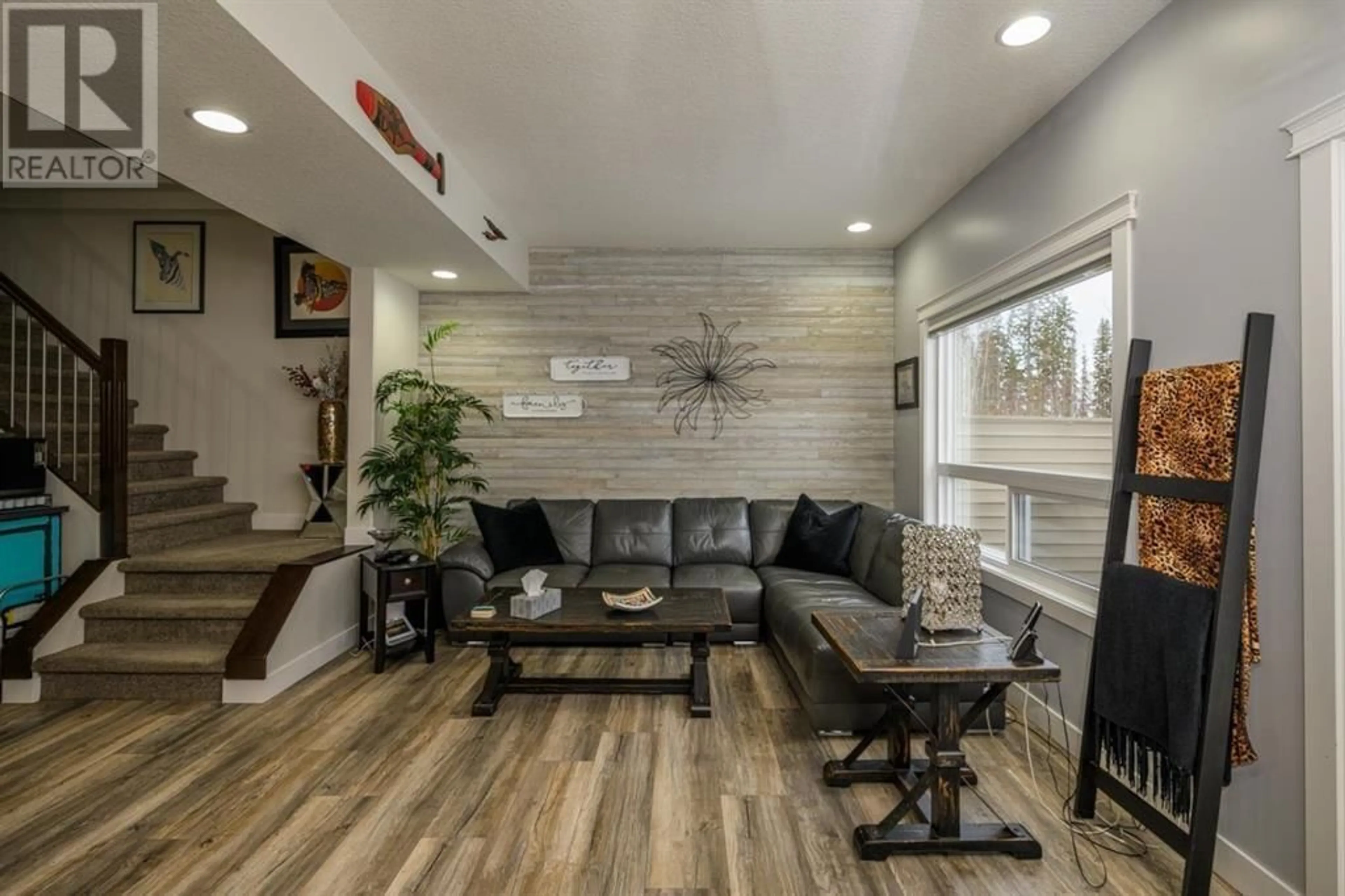 Living room with furniture, wood/laminate floor for 7654 CREEKSIDE WAY, Prince George British Columbia V2N0C2