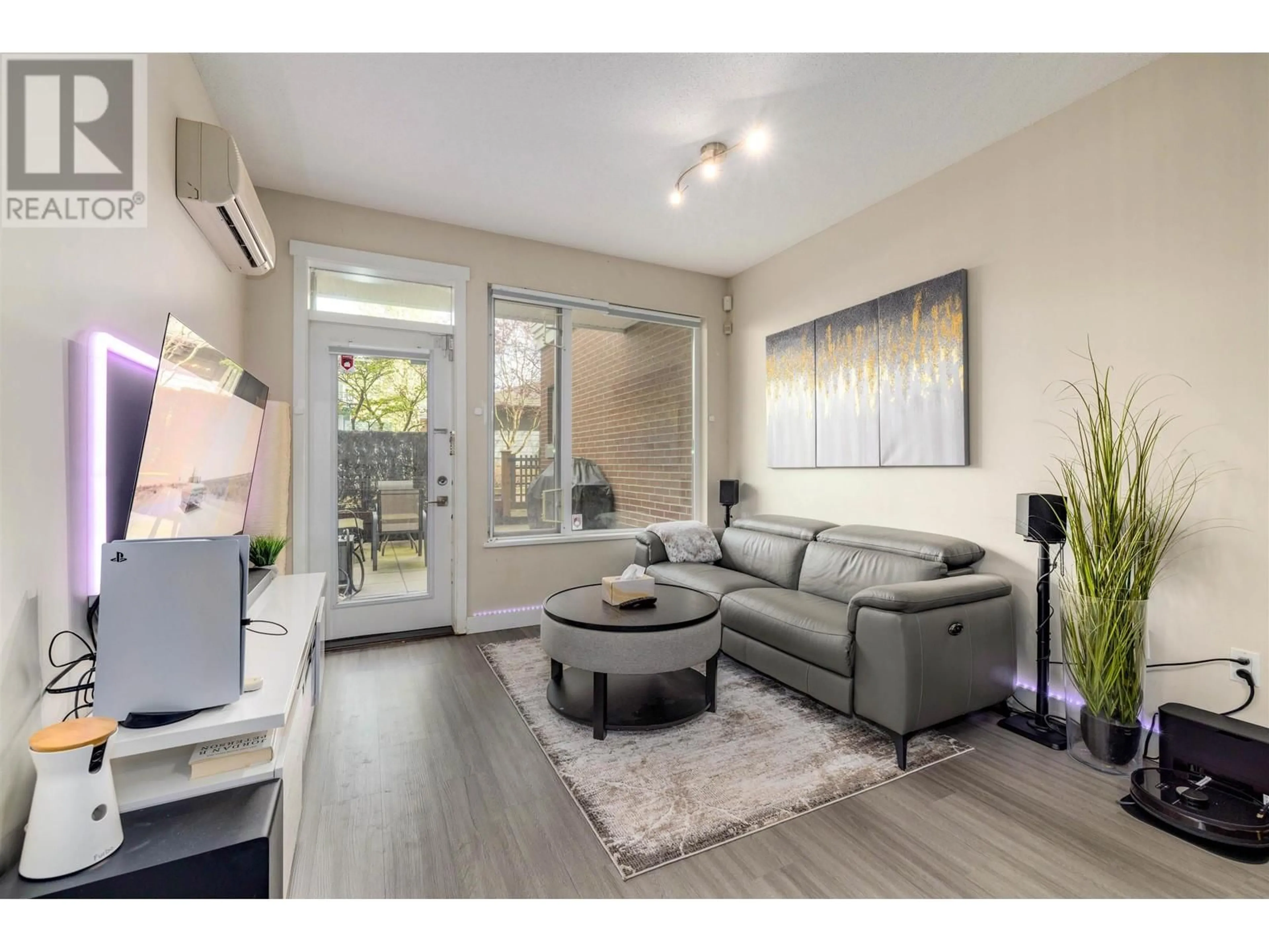 Living room with furniture, wood/laminate floor for 122 - 9399 ODLIN ROAD, Richmond British Columbia V6X1E1