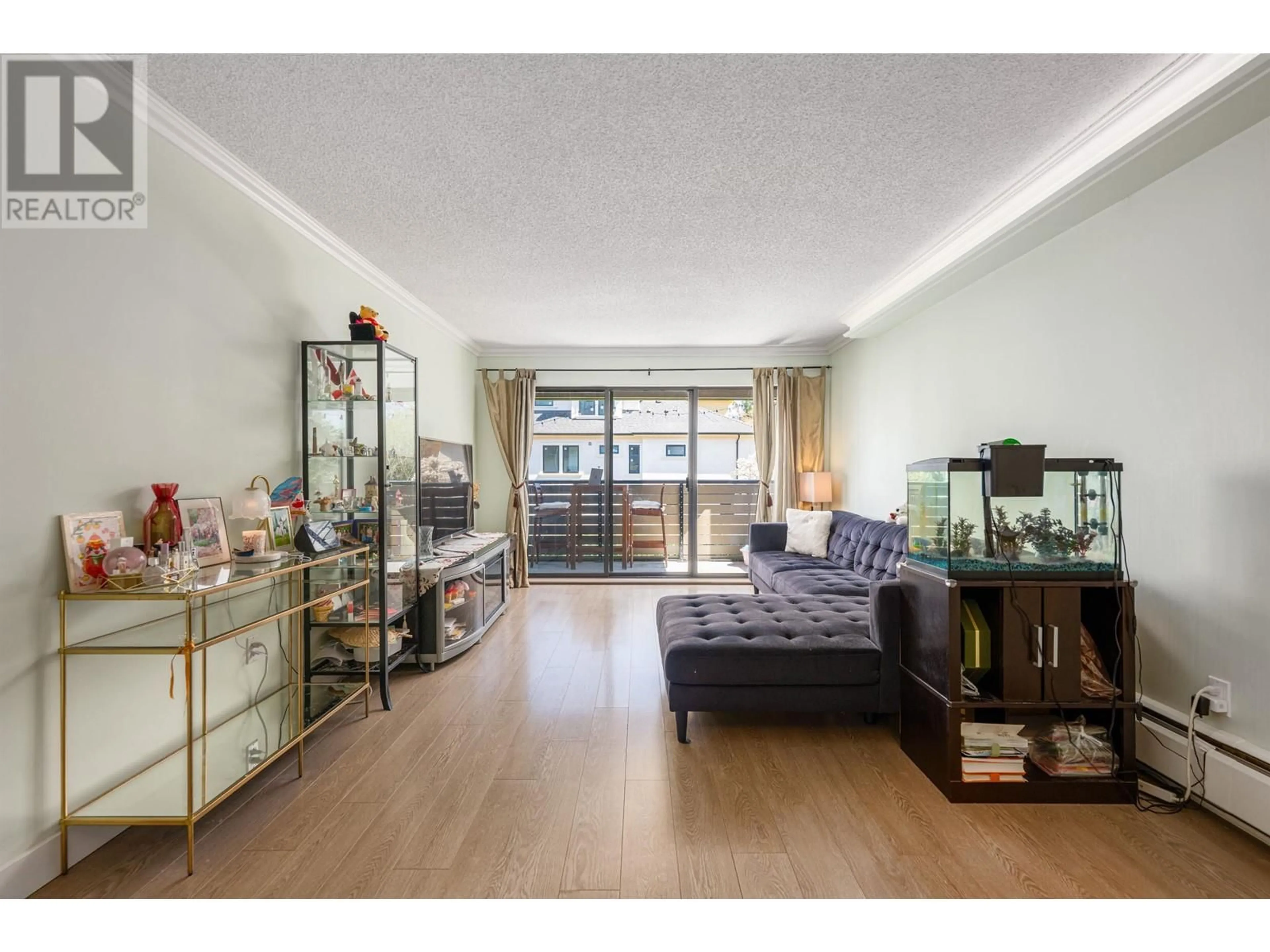 Living room with furniture, wood/laminate floor for 116 - 8880 NO. 1 ROAD, Richmond British Columbia V7C4C3