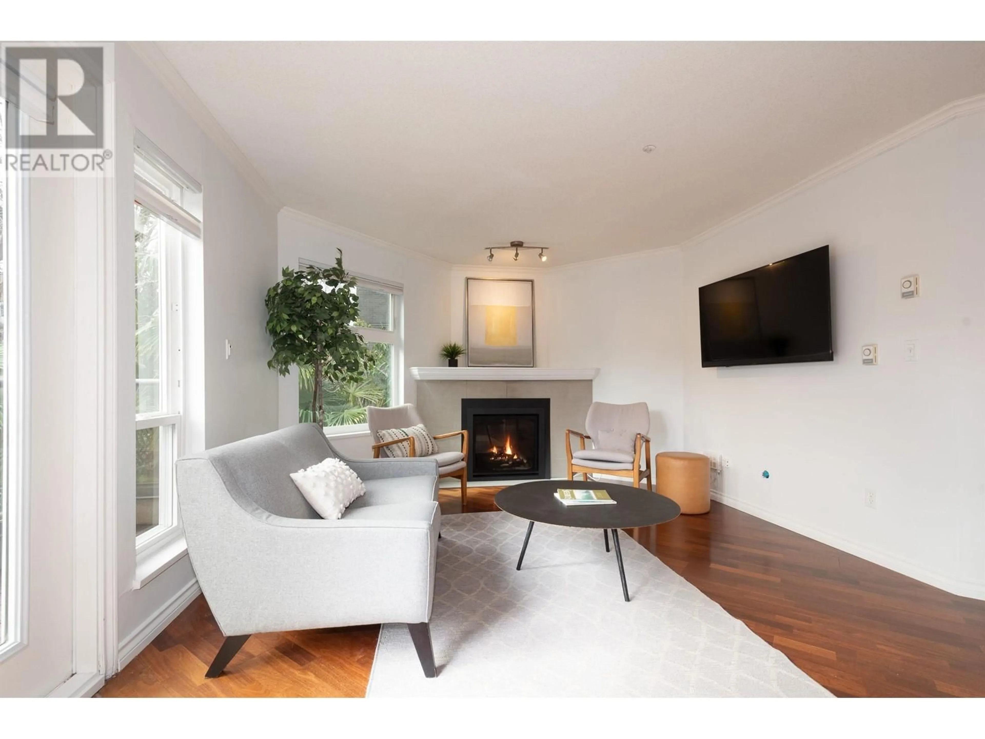 Living room with furniture, wood/laminate floor for 202 - 1959 2ND AVENUE, Vancouver British Columbia V6J1J2