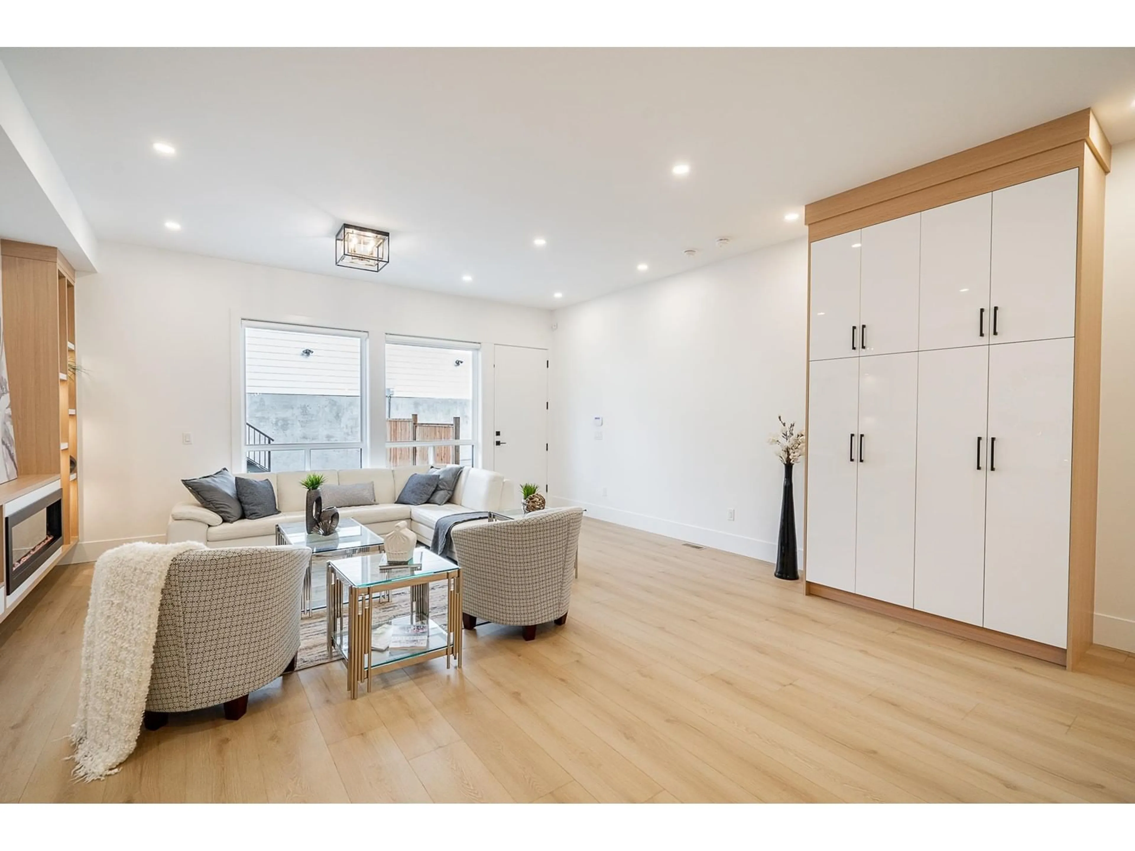 Living room with furniture, wood/laminate floor for 16677 16, Surrey British Columbia V3S9X7