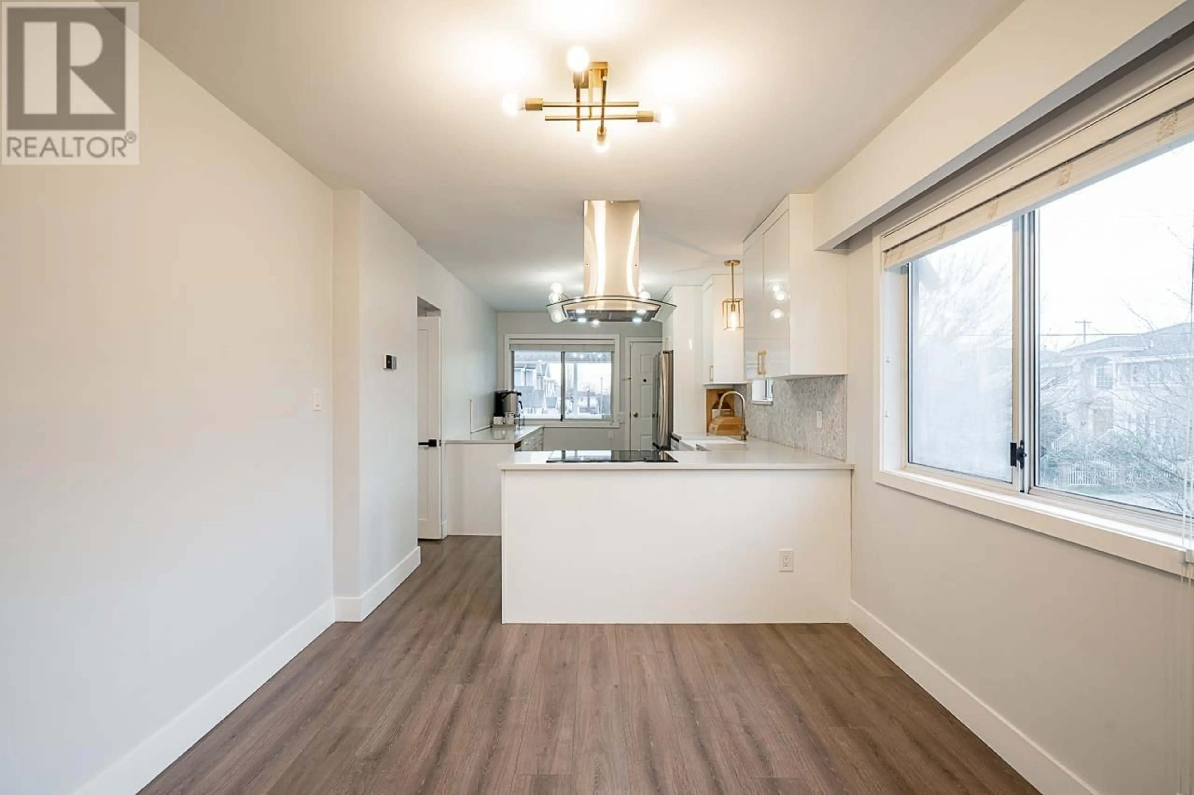 Open concept kitchen, wood/laminate floor for 2408 54TH AVENUE, Vancouver British Columbia V5S1X3