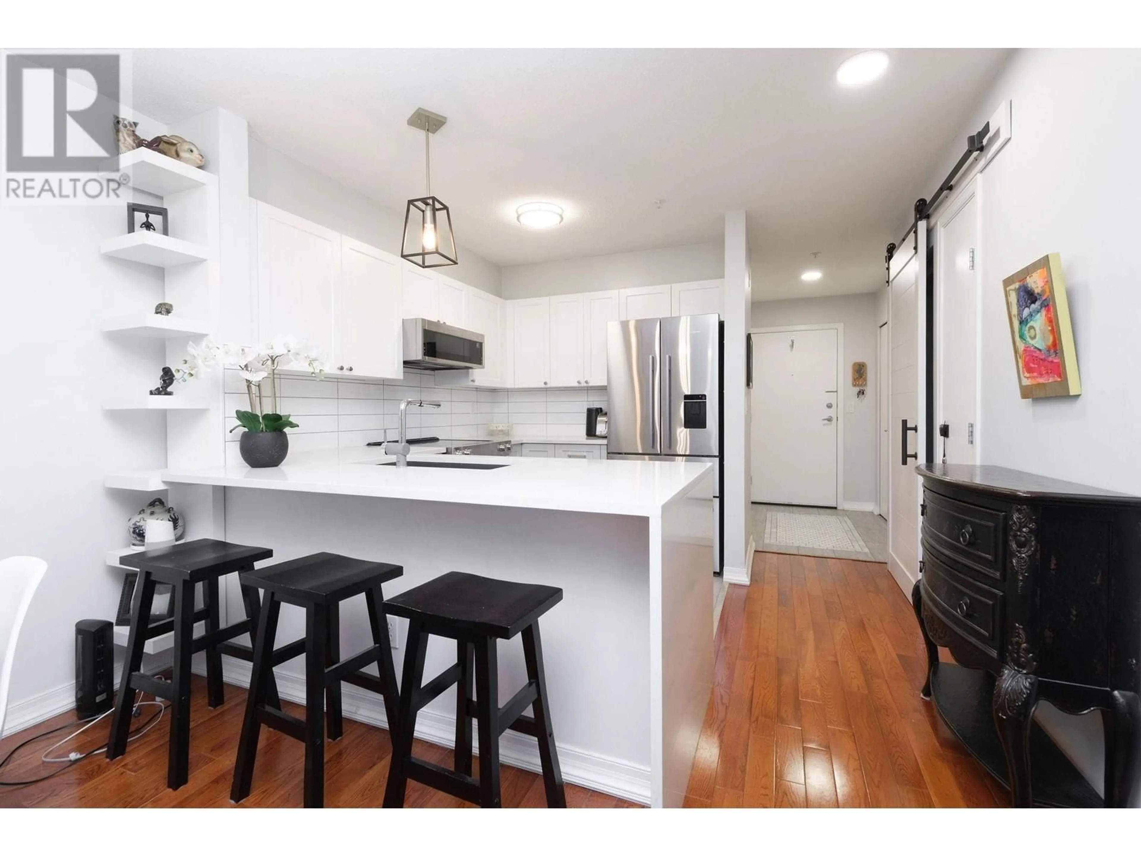 Open concept kitchen, wood/laminate floor for 215 - 147 1ST STREET, North Vancouver British Columbia V7L1B2