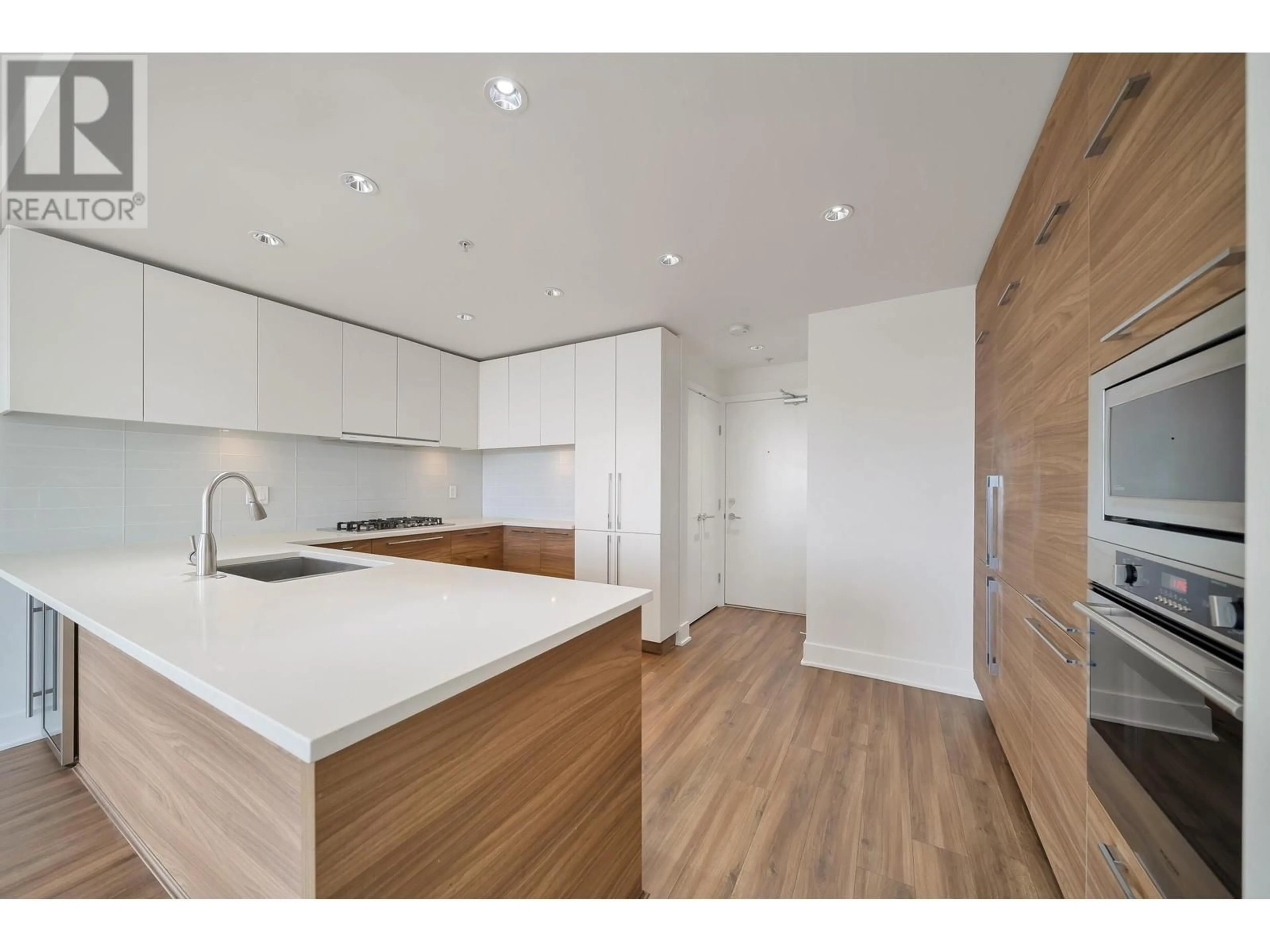 Open concept kitchen, wood/laminate floor for 3501 - 1188 PINETREE WAY, Coquitlam British Columbia V3B0K9