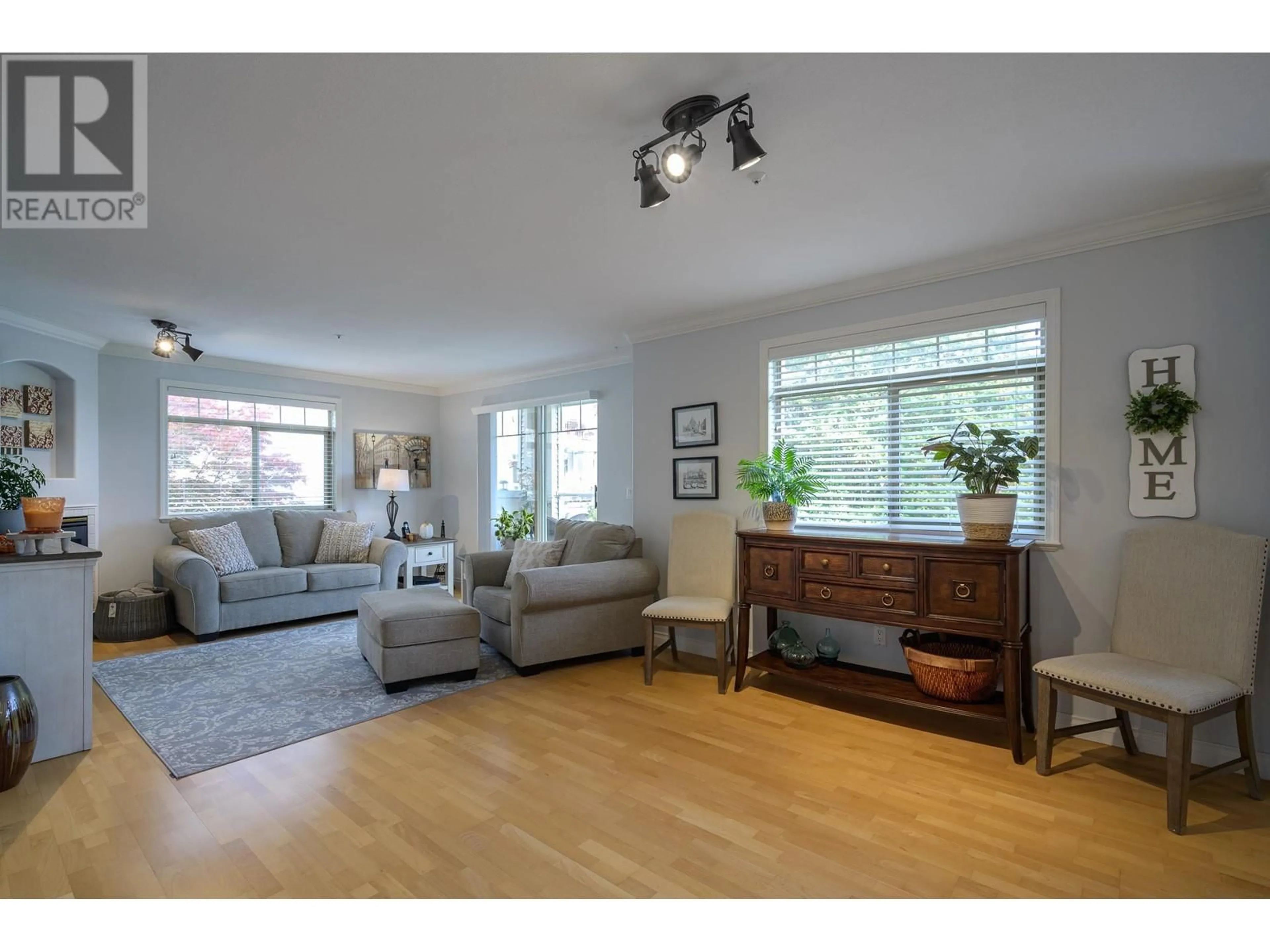 Living room with furniture, wood/laminate floor for A203 - 1258 HUNTER ROAD, Delta British Columbia V4L1Y8