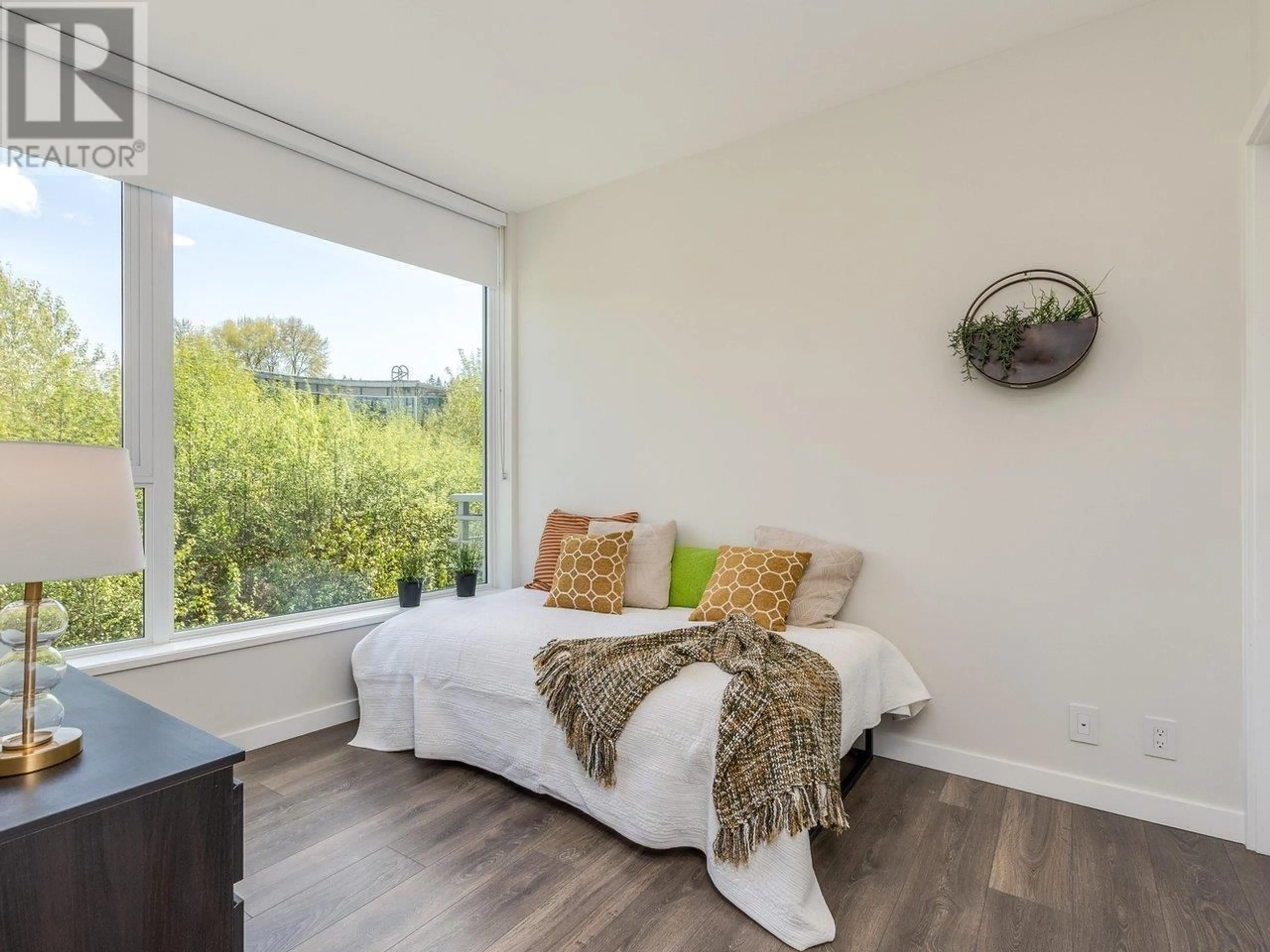 Living room with furniture, wood/laminate floor for 402 - 308 MORRISSEY ROAD, Port Moody British Columbia V3H0M2