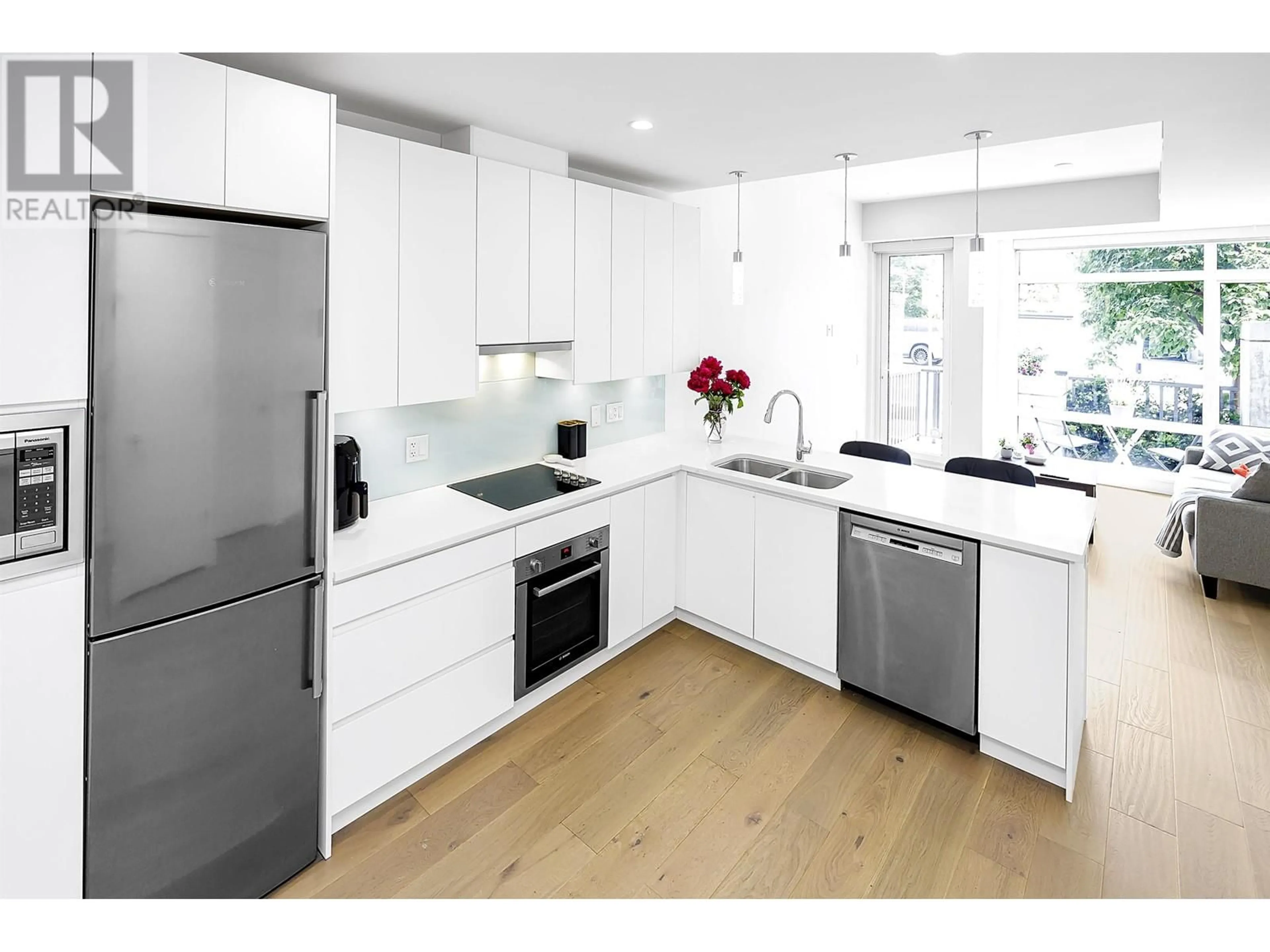 Contemporary kitchen, wood/laminate floor for 105 - 1591 BOWSER AVENUE, North Vancouver British Columbia V7P2Y4