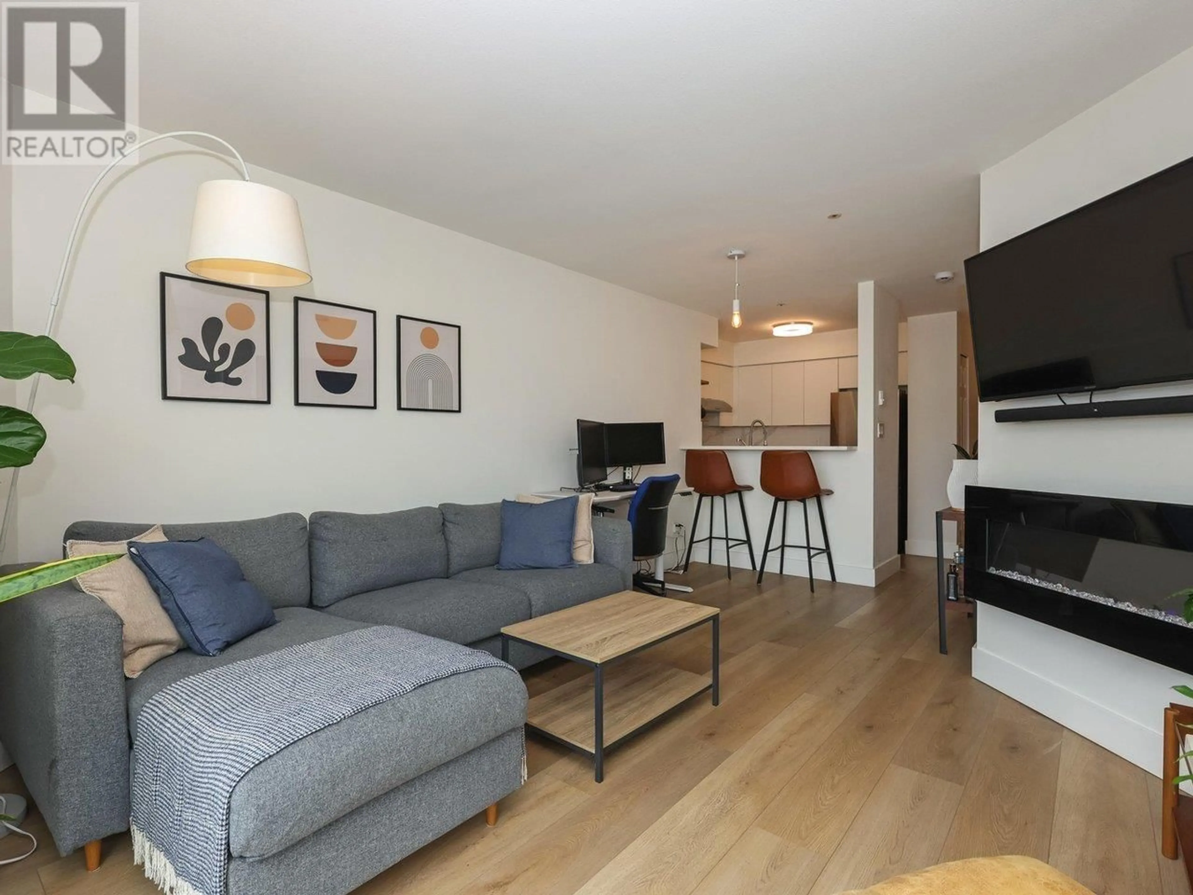 Living room with furniture, wood/laminate floor for 302 - 3505 BROADWAY, Vancouver British Columbia V6R2B5