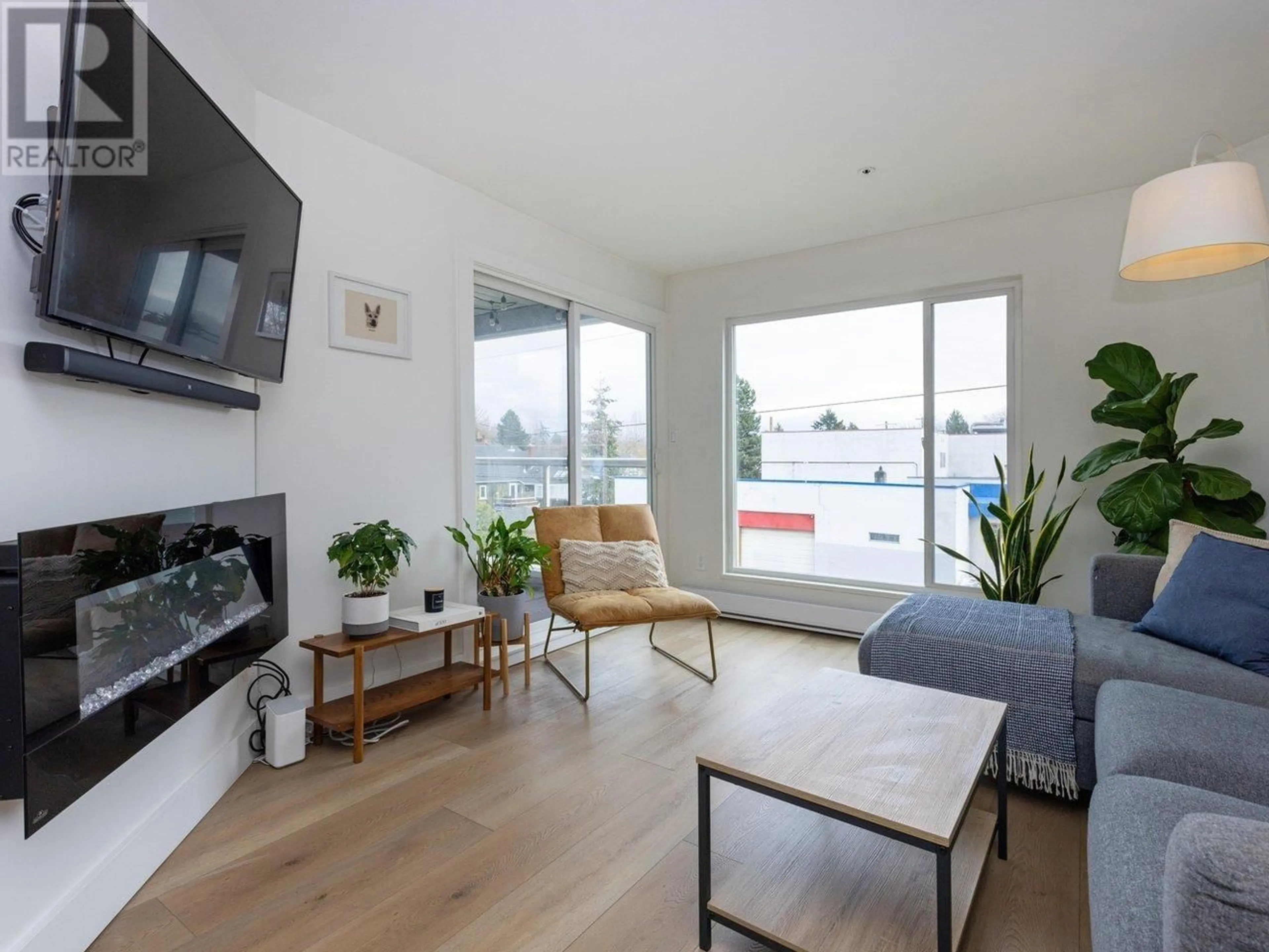 Living room with furniture, wood/laminate floor for 302 - 3505 BROADWAY, Vancouver British Columbia V6R2B5