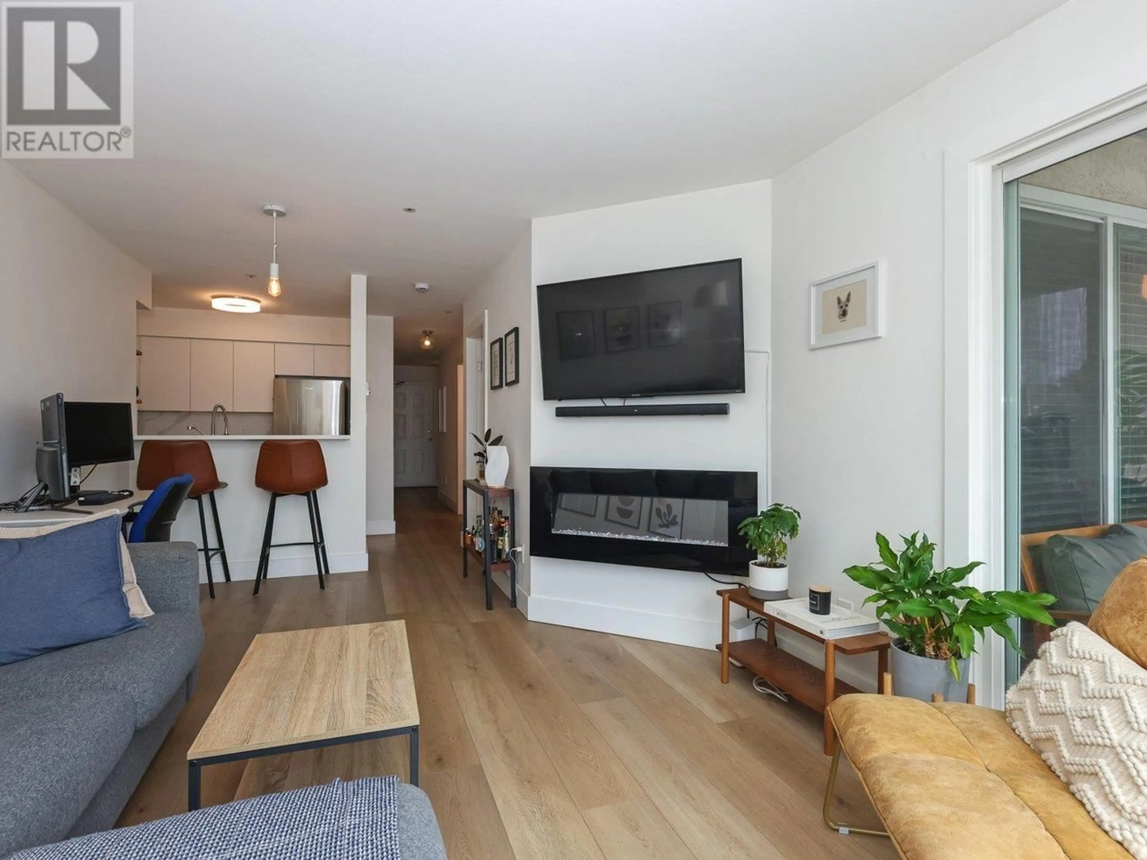 Living room with furniture, wood/laminate floor for 302 - 3505 BROADWAY, Vancouver British Columbia V6R2B5