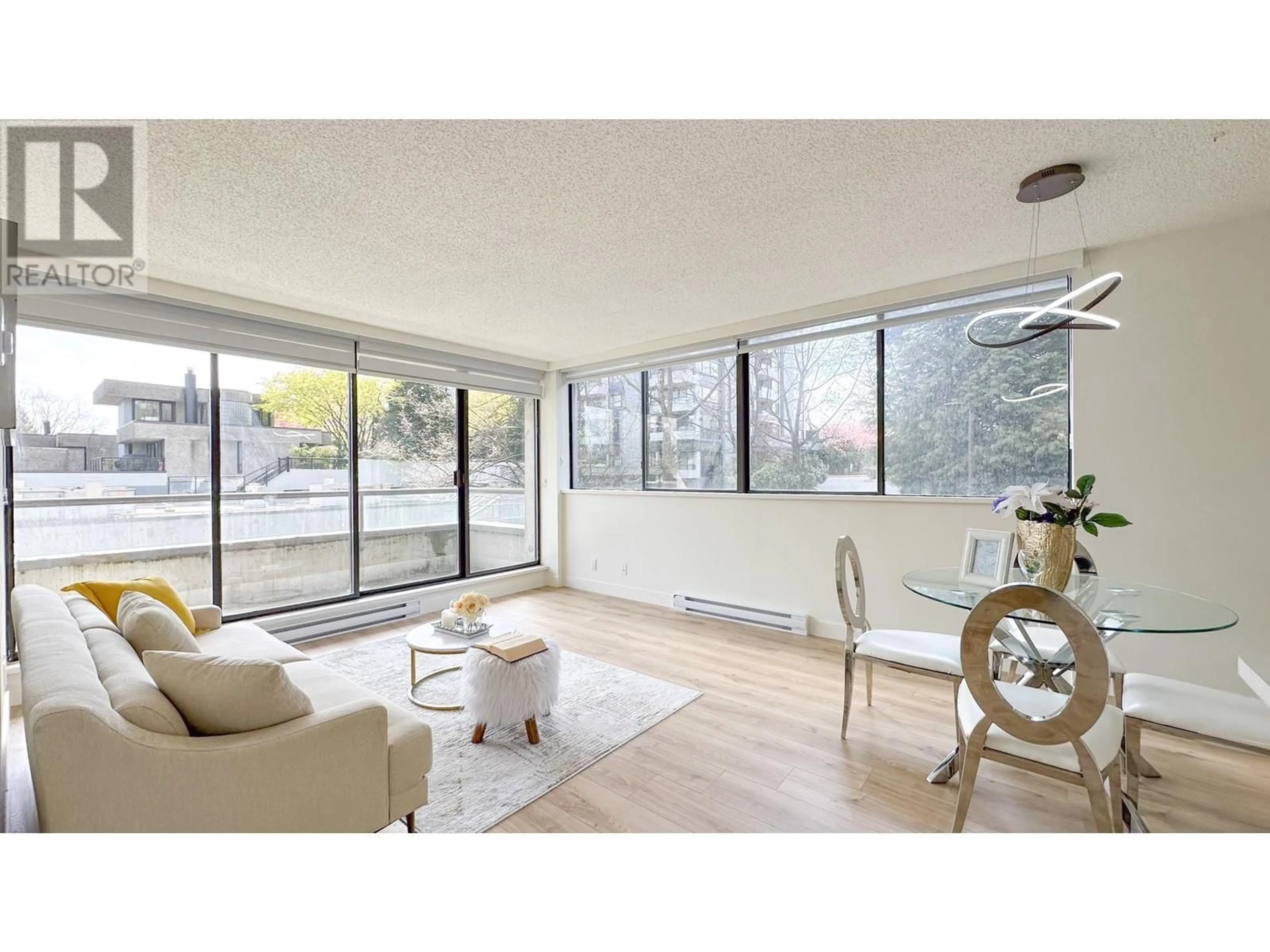 Living room with furniture, wood/laminate floor for 204 - 3970 CARRIGAN COURT, Burnaby British Columbia V3N4S5