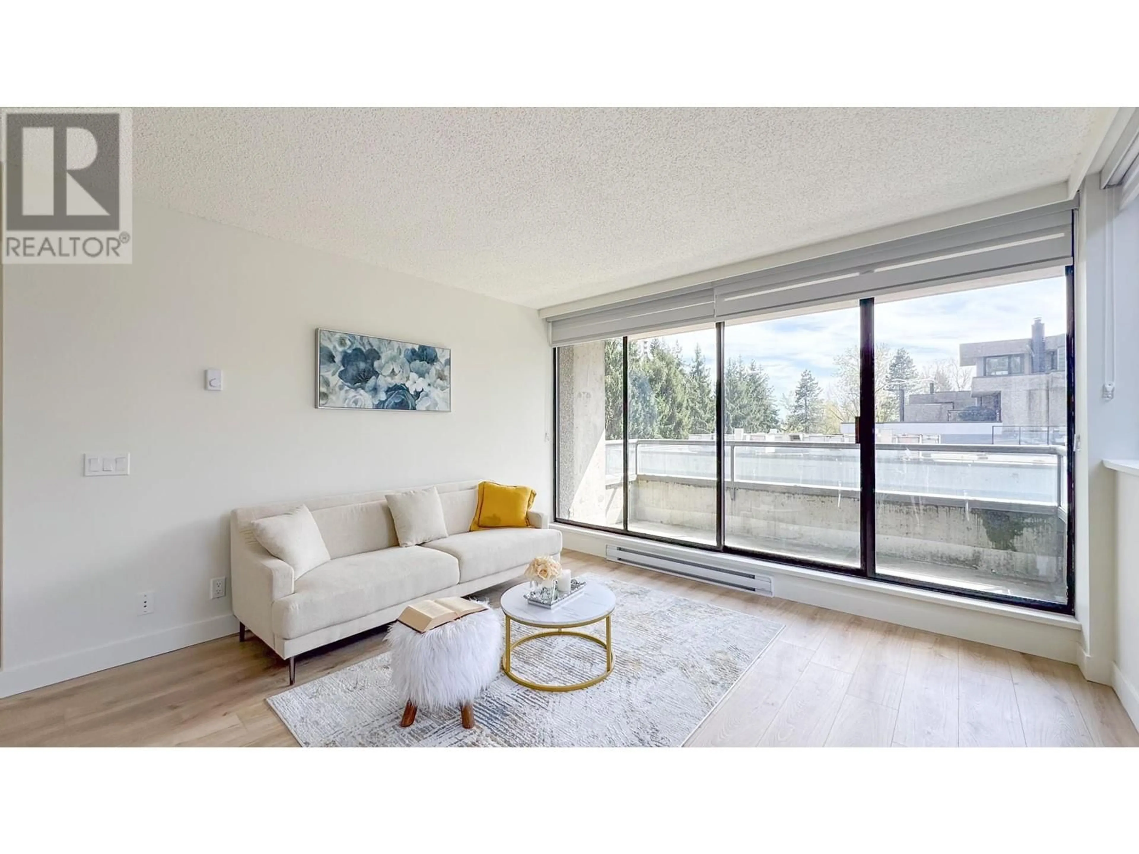 Living room with furniture, wood/laminate floor for 204 - 3970 CARRIGAN COURT, Burnaby British Columbia V3N4S5