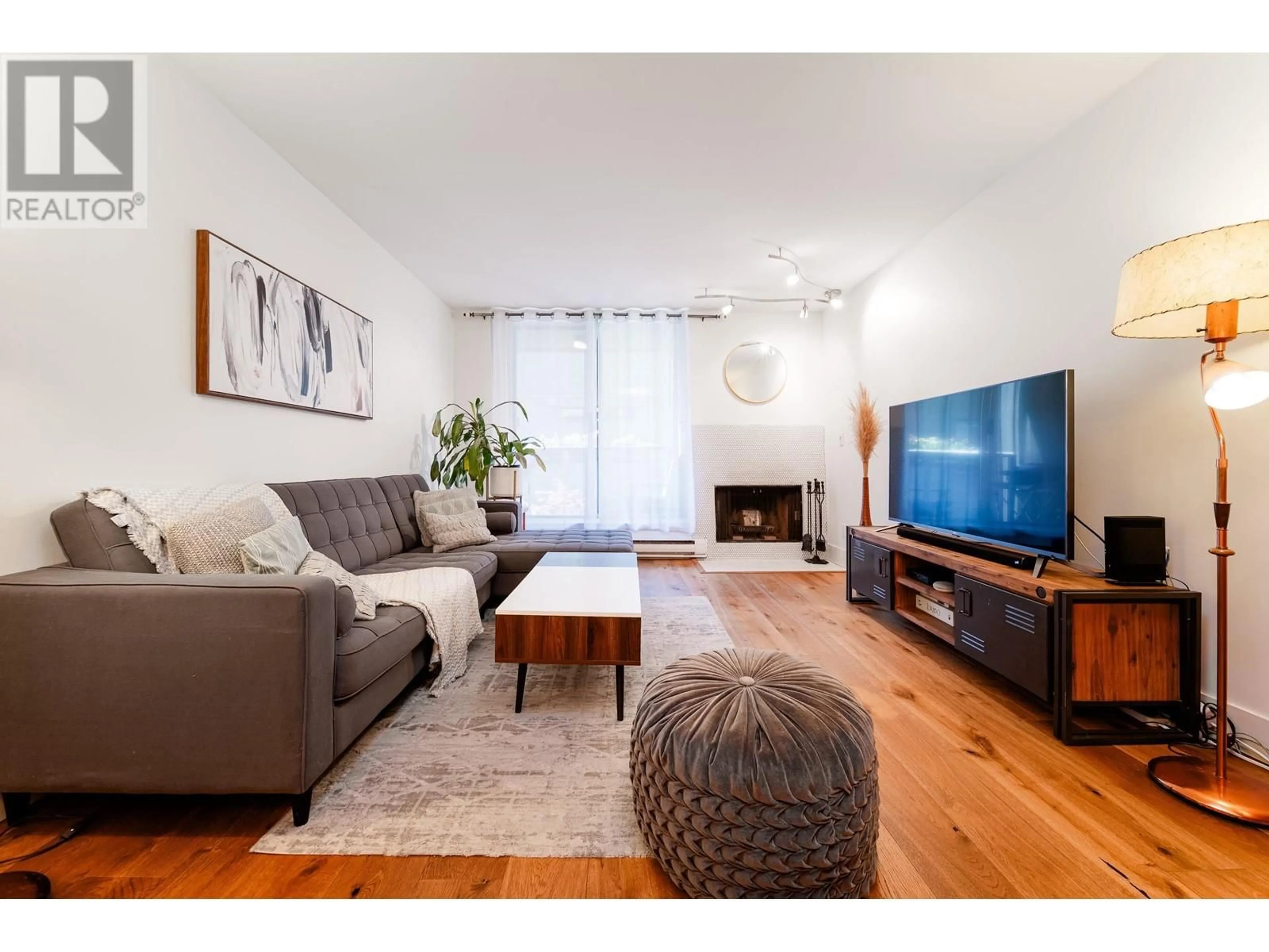 Living room with furniture, wood/laminate floor for 206 - 1232 HARWOOD STREET, Vancouver British Columbia V6E1S2
