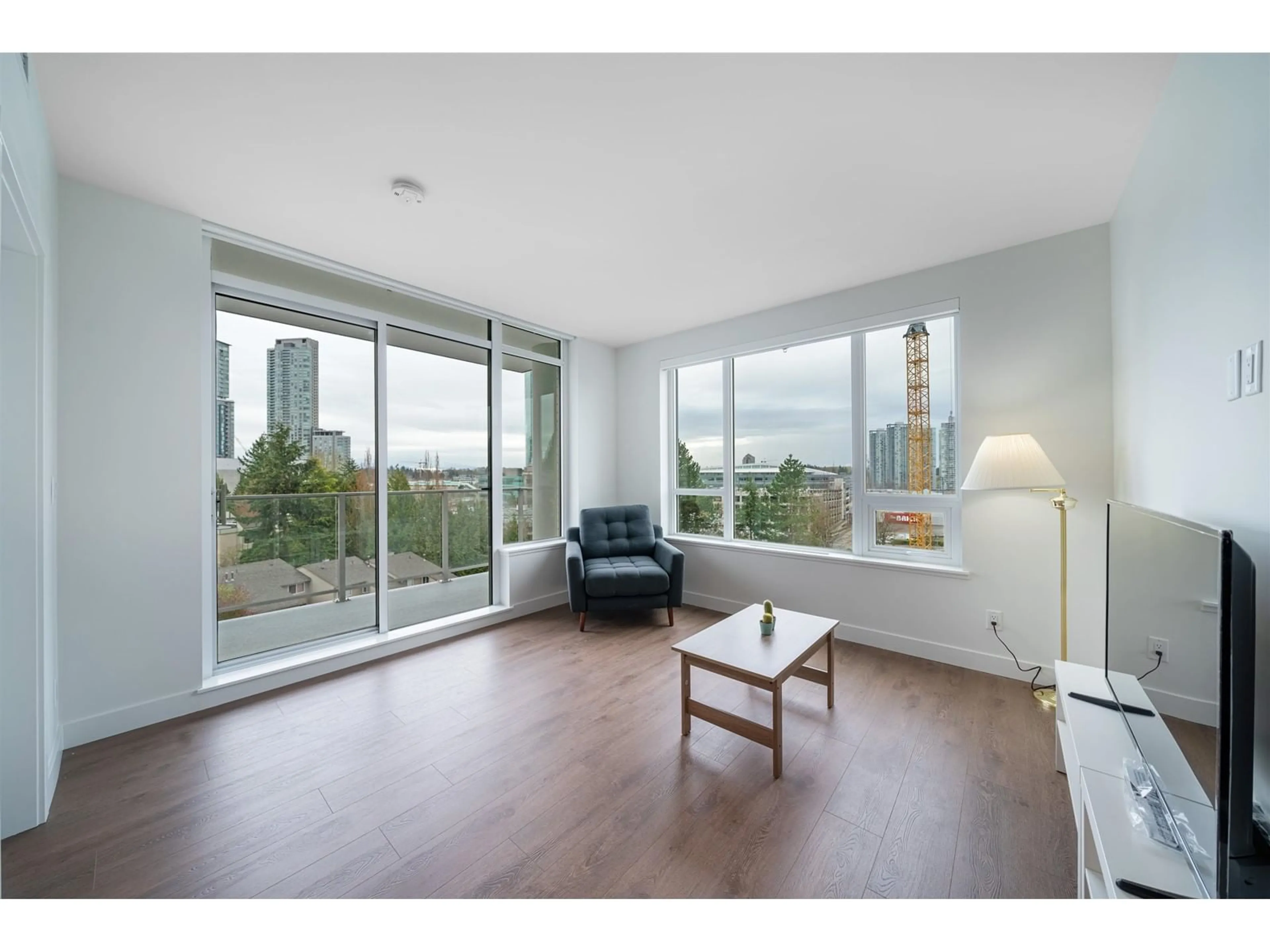 Living room with furniture, wood/laminate floor for 402 - 13359 OLD YALE, Surrey British Columbia V3T0S4