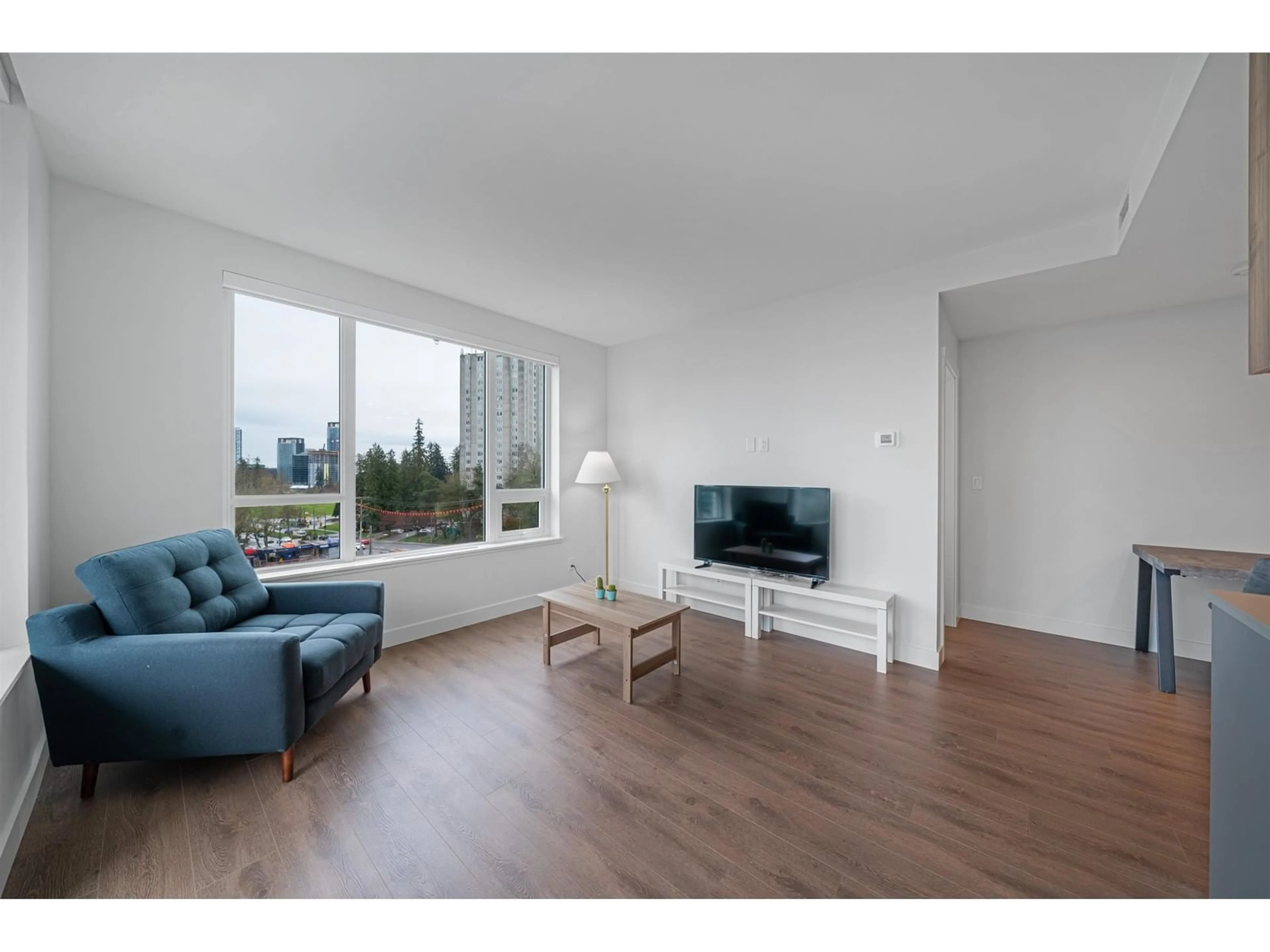 Living room with furniture, wood/laminate floor for 402 - 13359 OLD YALE, Surrey British Columbia V3T0S4