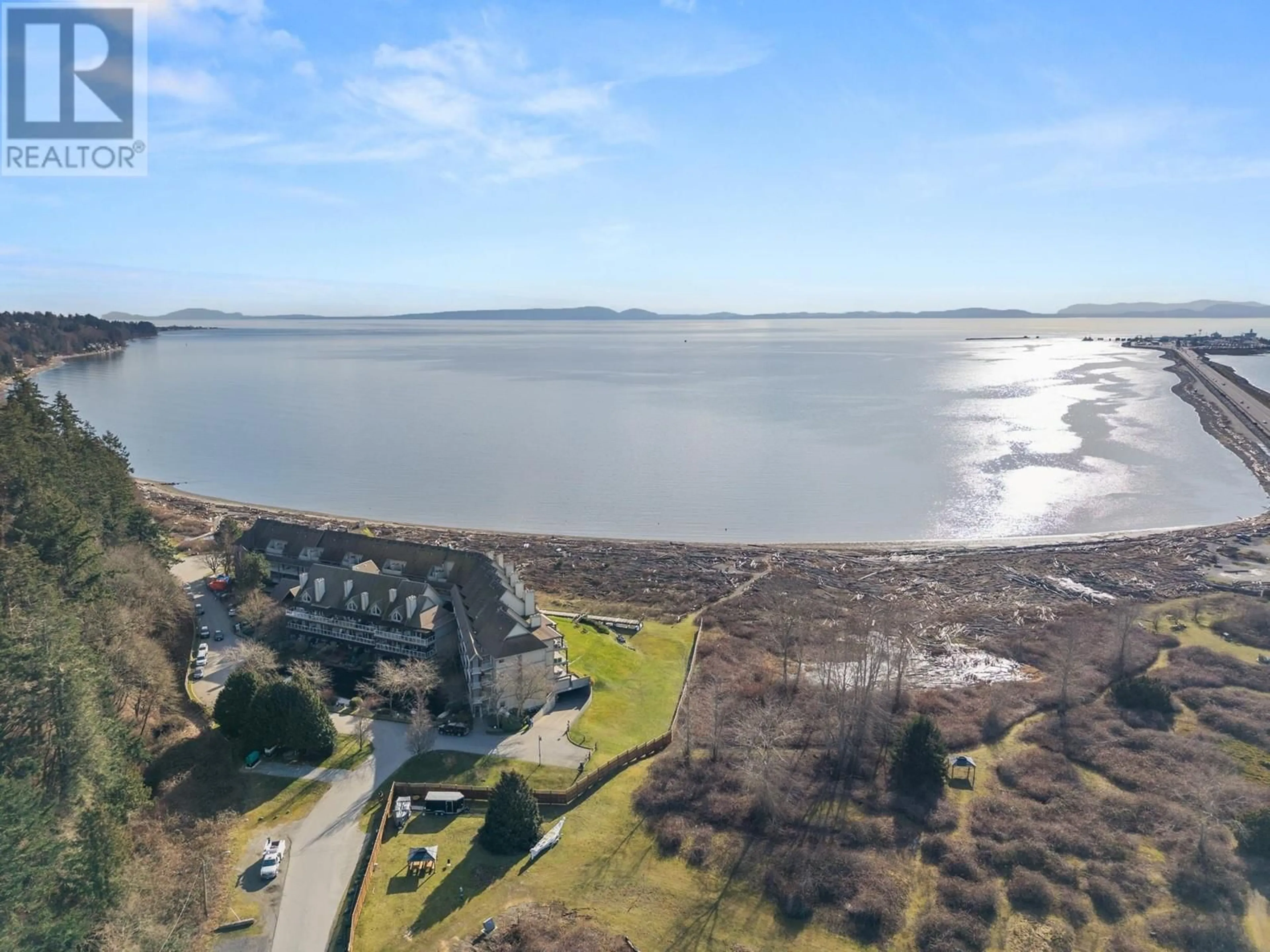 A pic from outside/outdoor area/front of a property/back of a property/a pic from drone, water/lake/river/ocean view for 203 - 1120 TSATSU SHORES DRIVE, Tsawwassen British Columbia V4M4G3