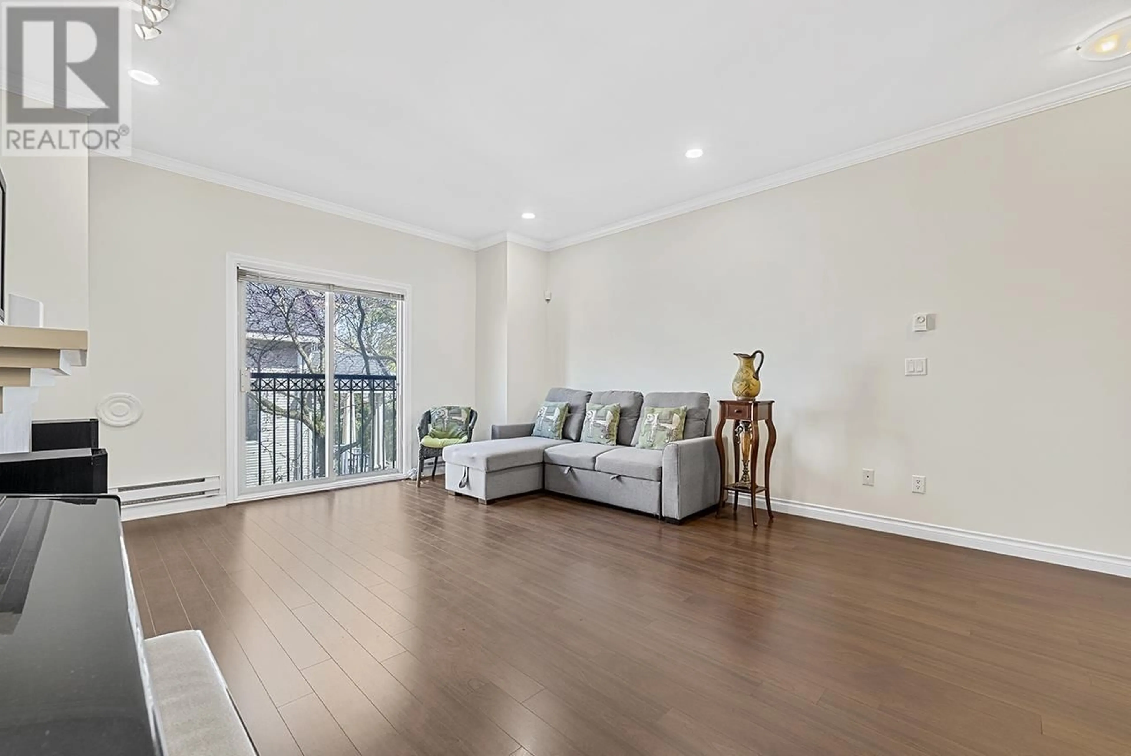 Living room with furniture, wood/laminate floor for 2 - 8171 NO. 2 ROAD, Richmond British Columbia V7C3M2