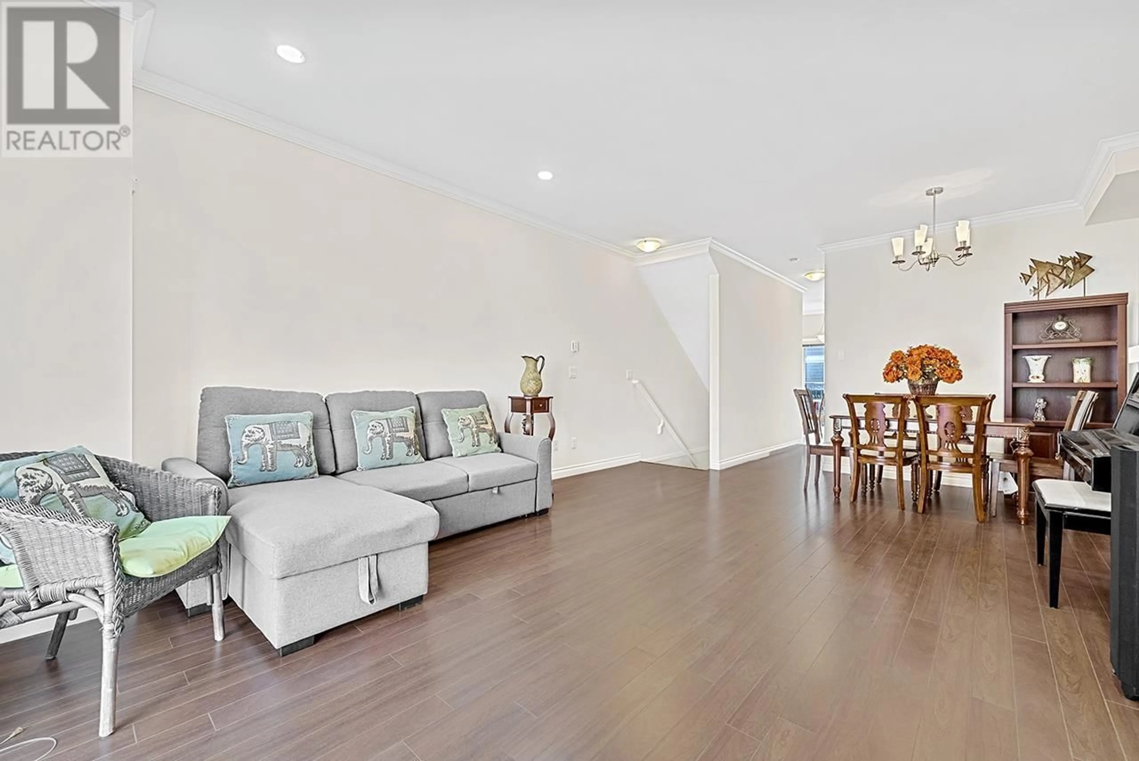Living room with furniture, wood/laminate floor for 2 - 8171 NO. 2 ROAD, Richmond British Columbia V7C3M2
