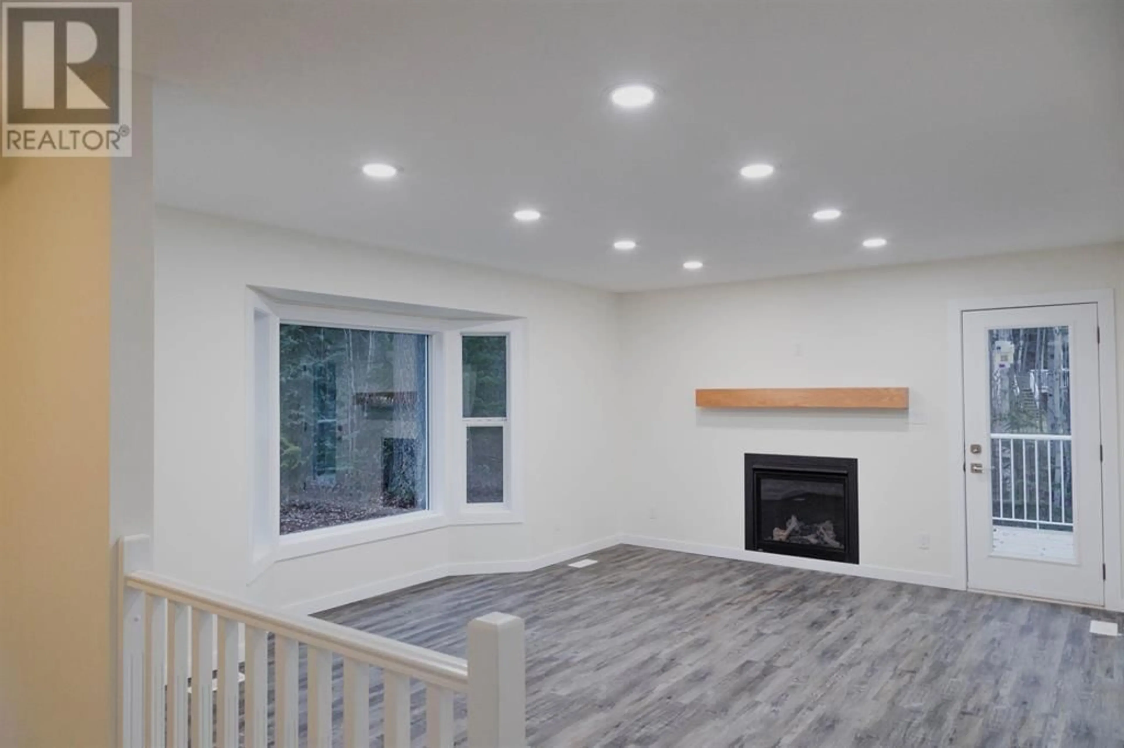 Living room with furniture, wood/laminate floor for 9685 MOSSMAN ROAD, Prince George British Columbia V2N5B3