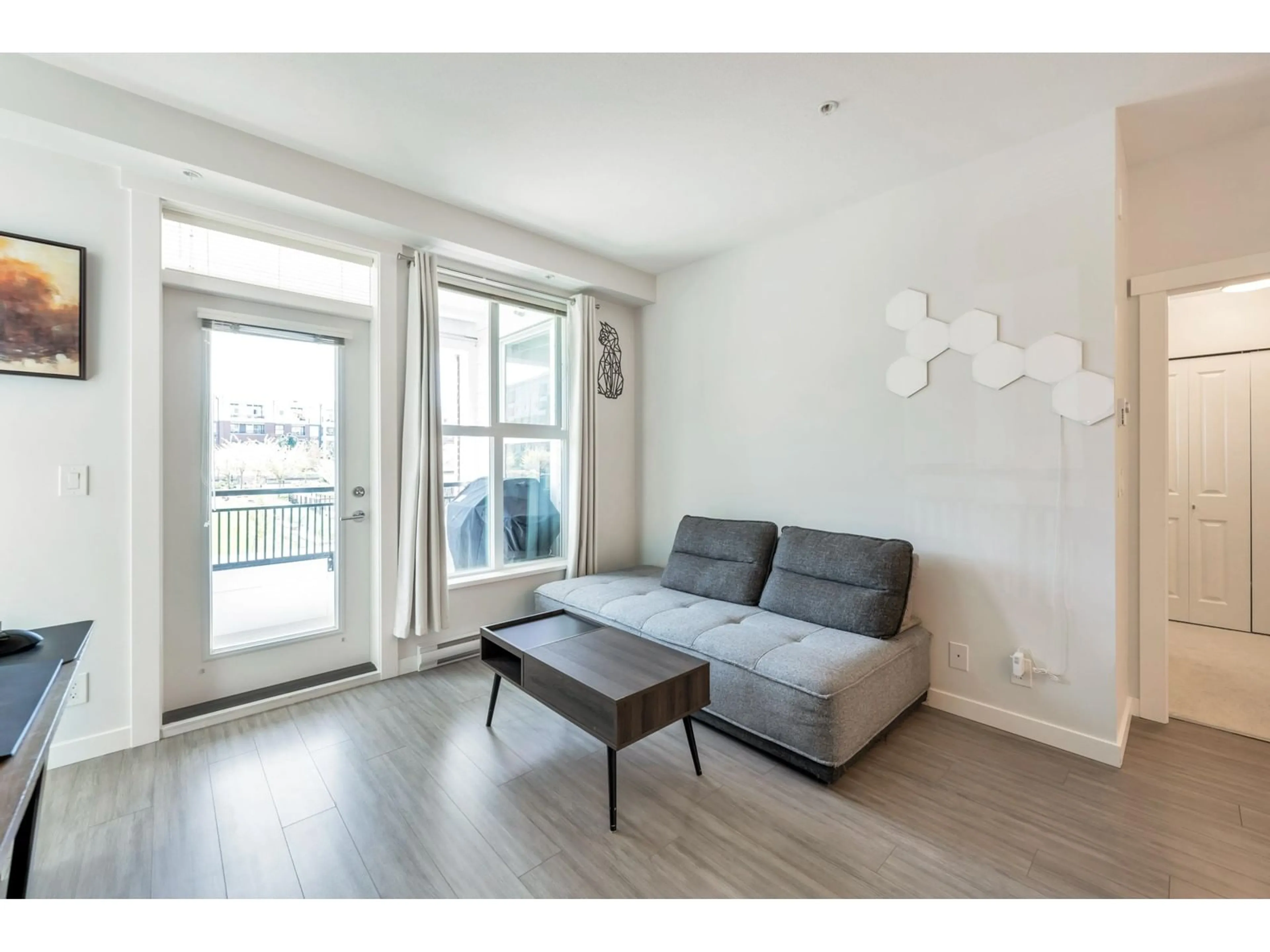 Living room with furniture, wood/laminate floor for B222 - 8150 207, Langley British Columbia V2Y4J3
