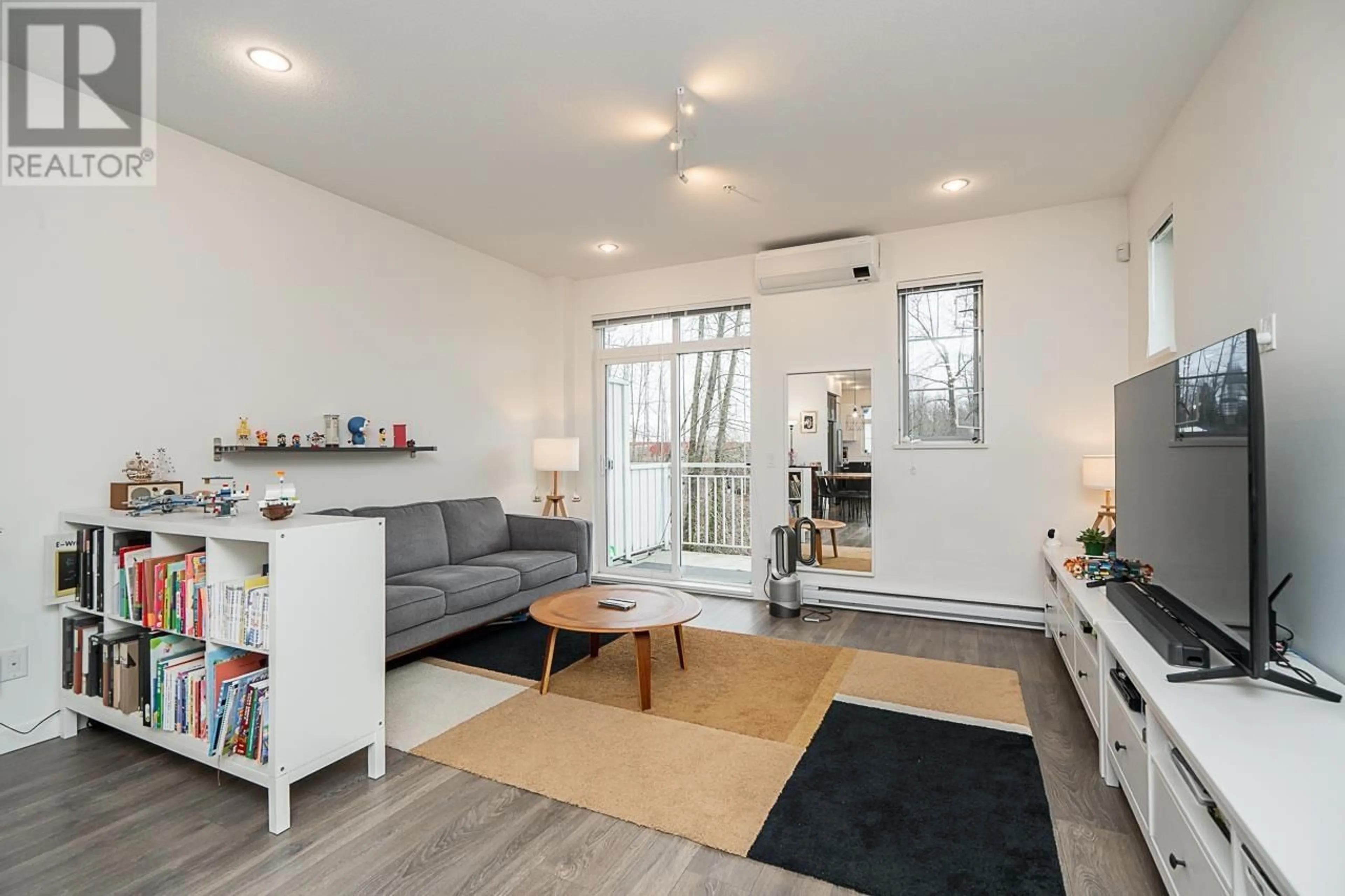 Living room with furniture, wood/laminate floor for 45 - 2560 PITT RIVER ROAD, Port Coquitlam British Columbia V3C0G6